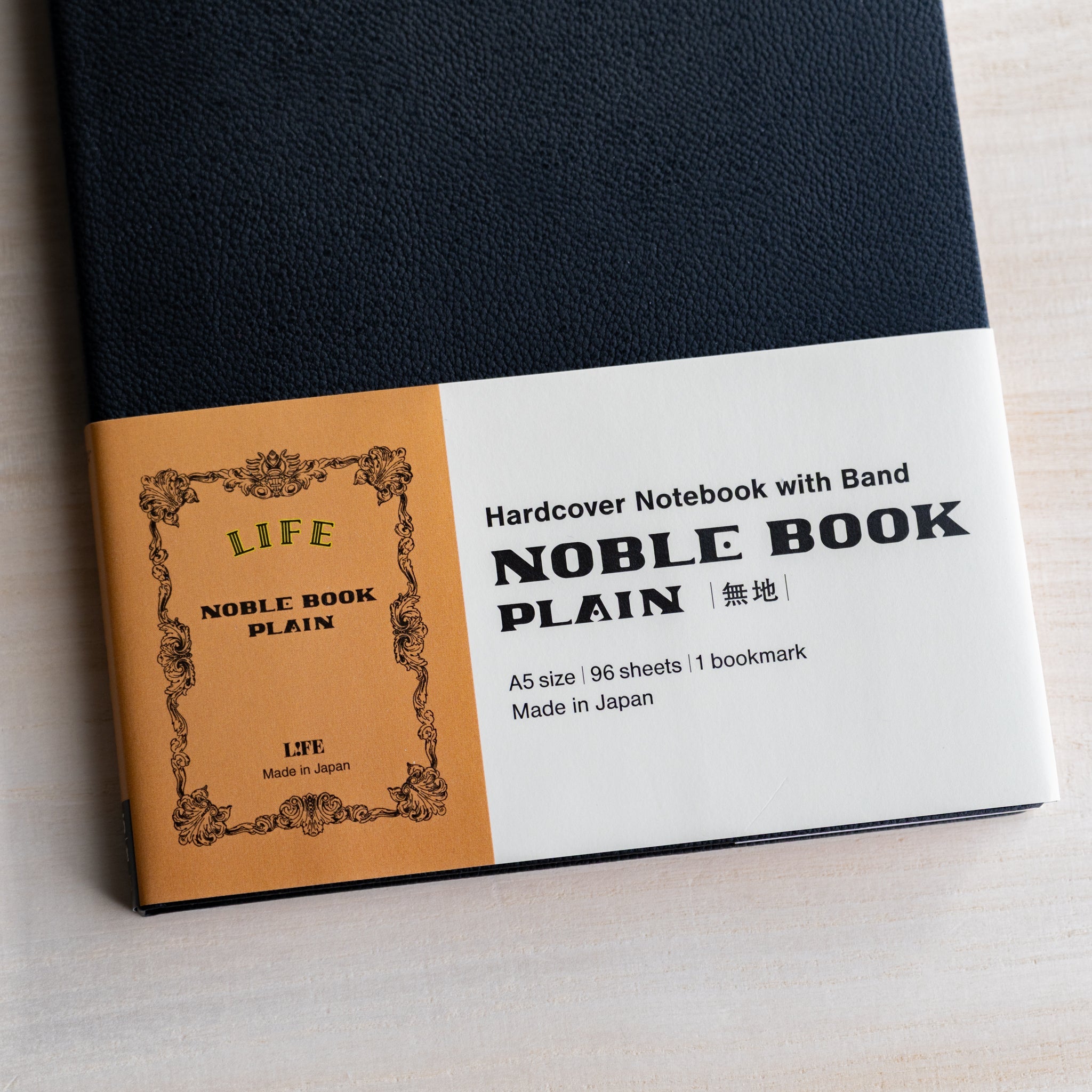 Life noble hard cover notebook A5 with paper belly band, black textured cover and product details label, made in Japan