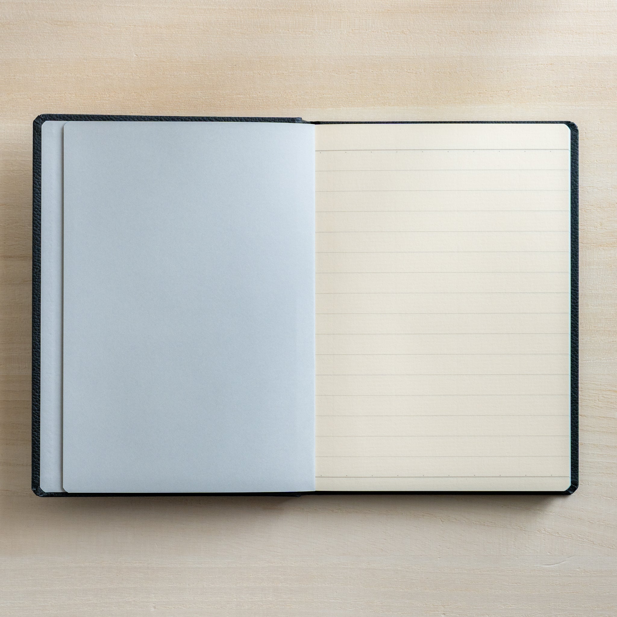 Life Noble notebook A6 open flat with lined L Writing Paper and pale gray flyleaf, showing neat ruling and compact layout