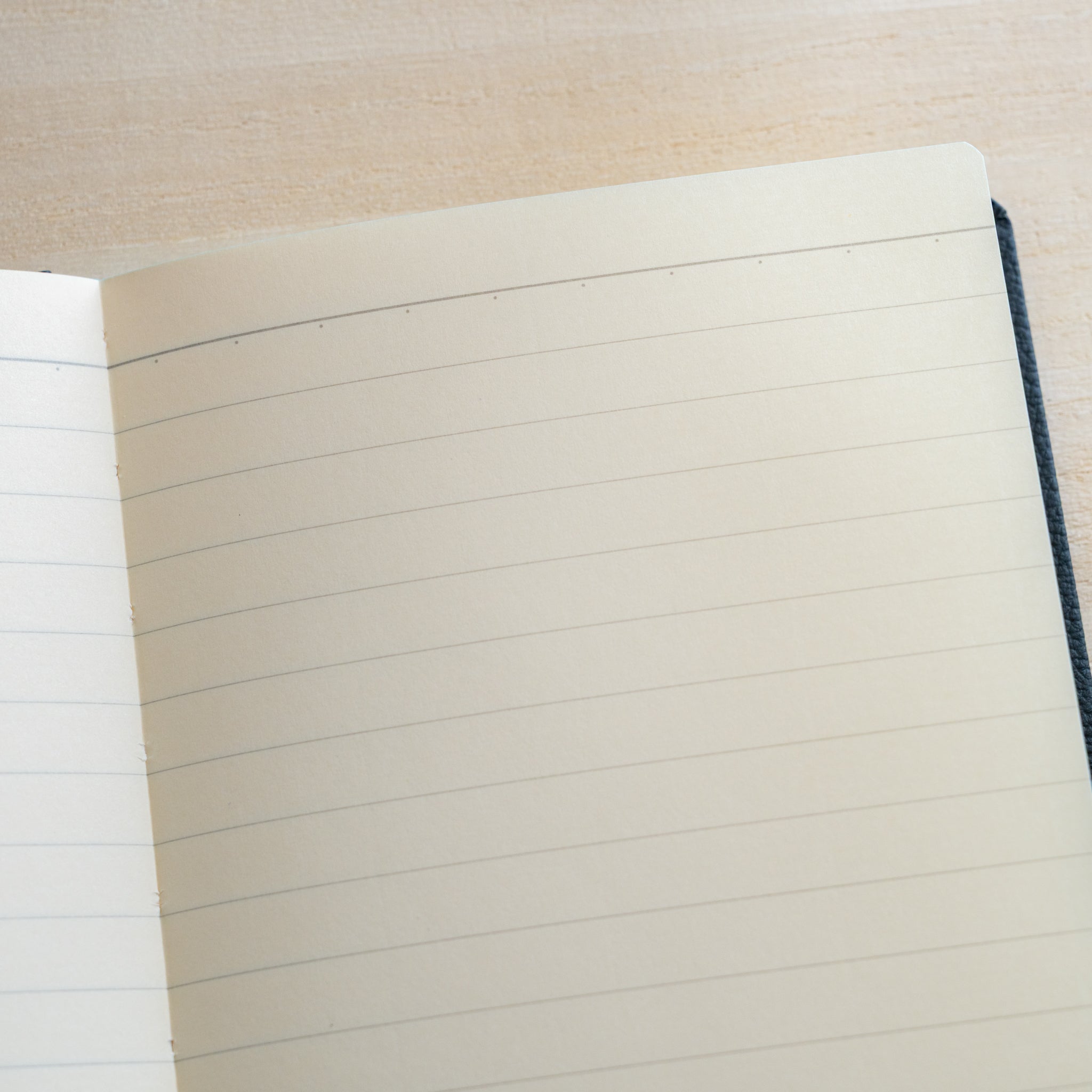 Life Noble notebook A6 open flat showing lined L Writing Paper, clean ruling, cream pages, and compact layout for everyday writing