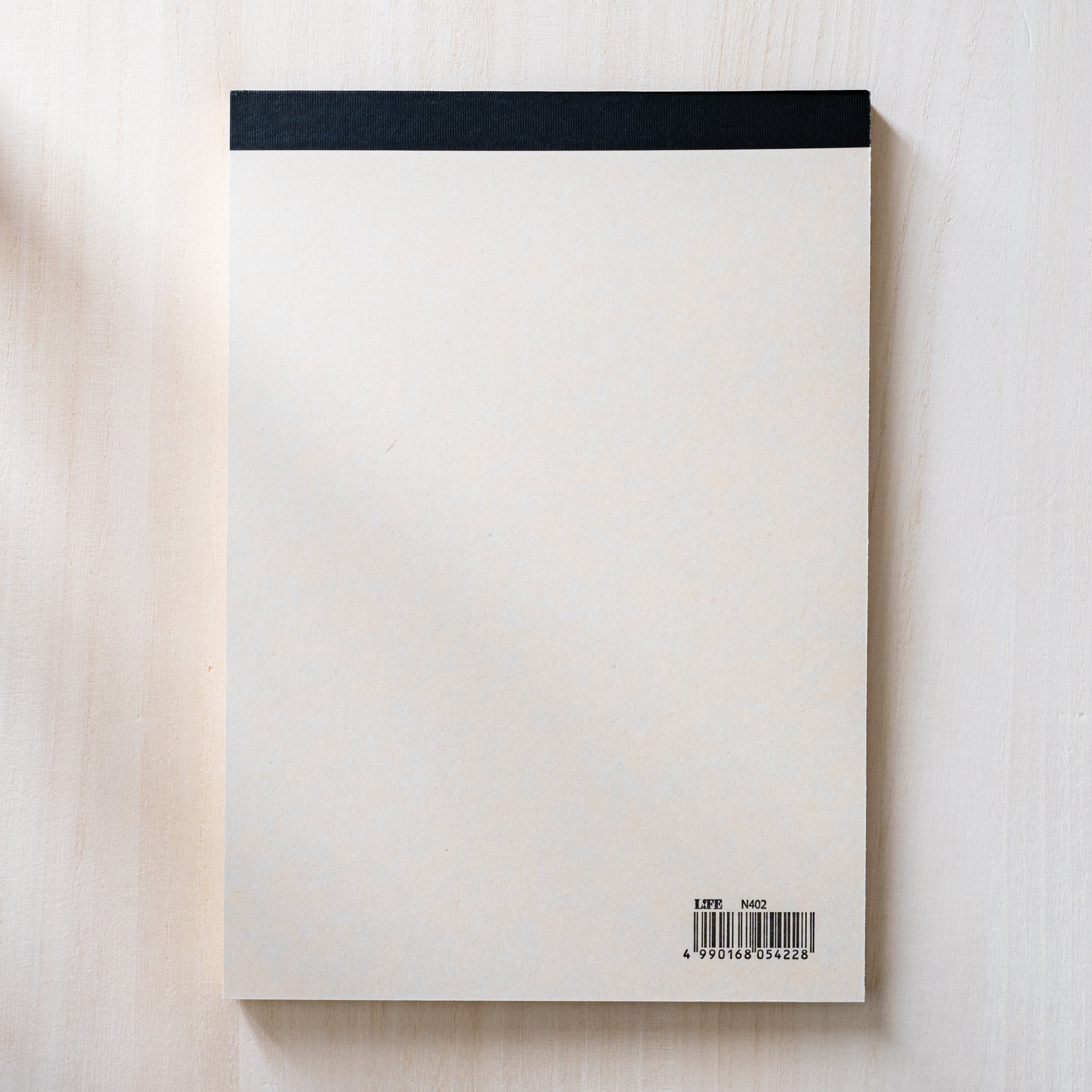 Life Noble writing pad back side with plain cream paper, black top binding and barcode, minimalist Japanese stationery pad
