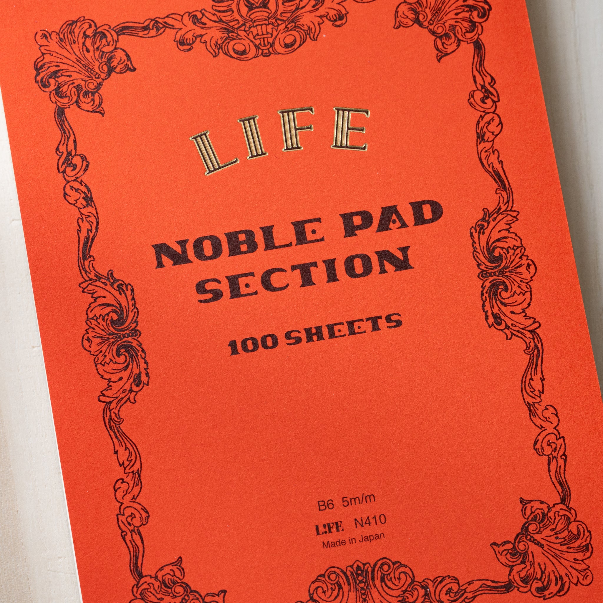 Life noble writing pad B6 orange Noble Pad Section cover close-up, LIFE logo, vintage frame design, 100 sheets text