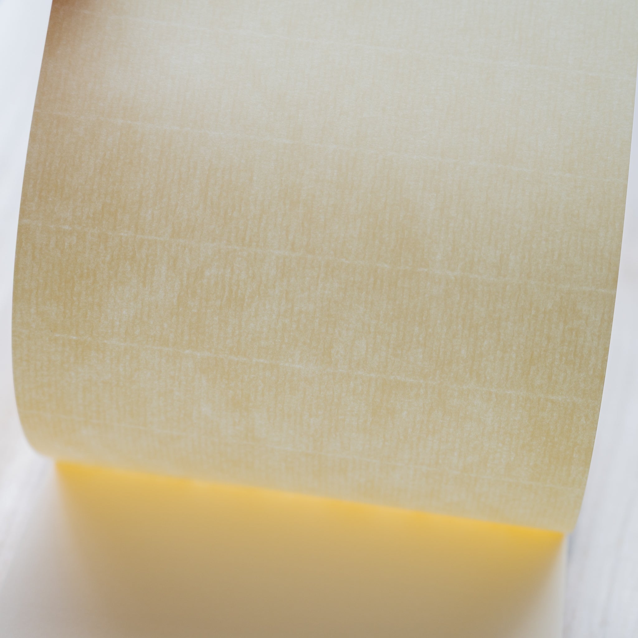 Life noble writing pad B6 extreme close-up showing cream L Writing Paper texture, softly curved sheet highlighting surface grain