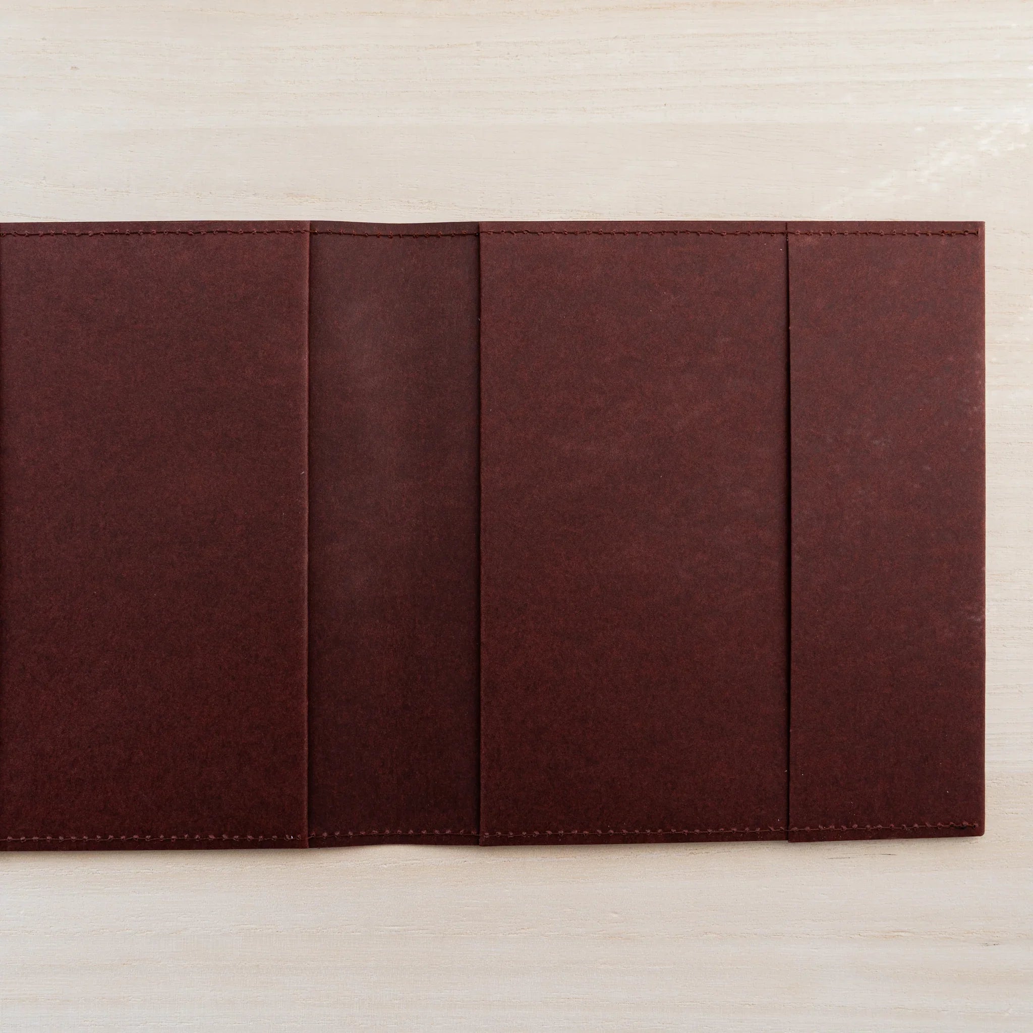Dark maroon MD Notebook Hard Cover A5 Square opened flat showing the firm paper inner panels