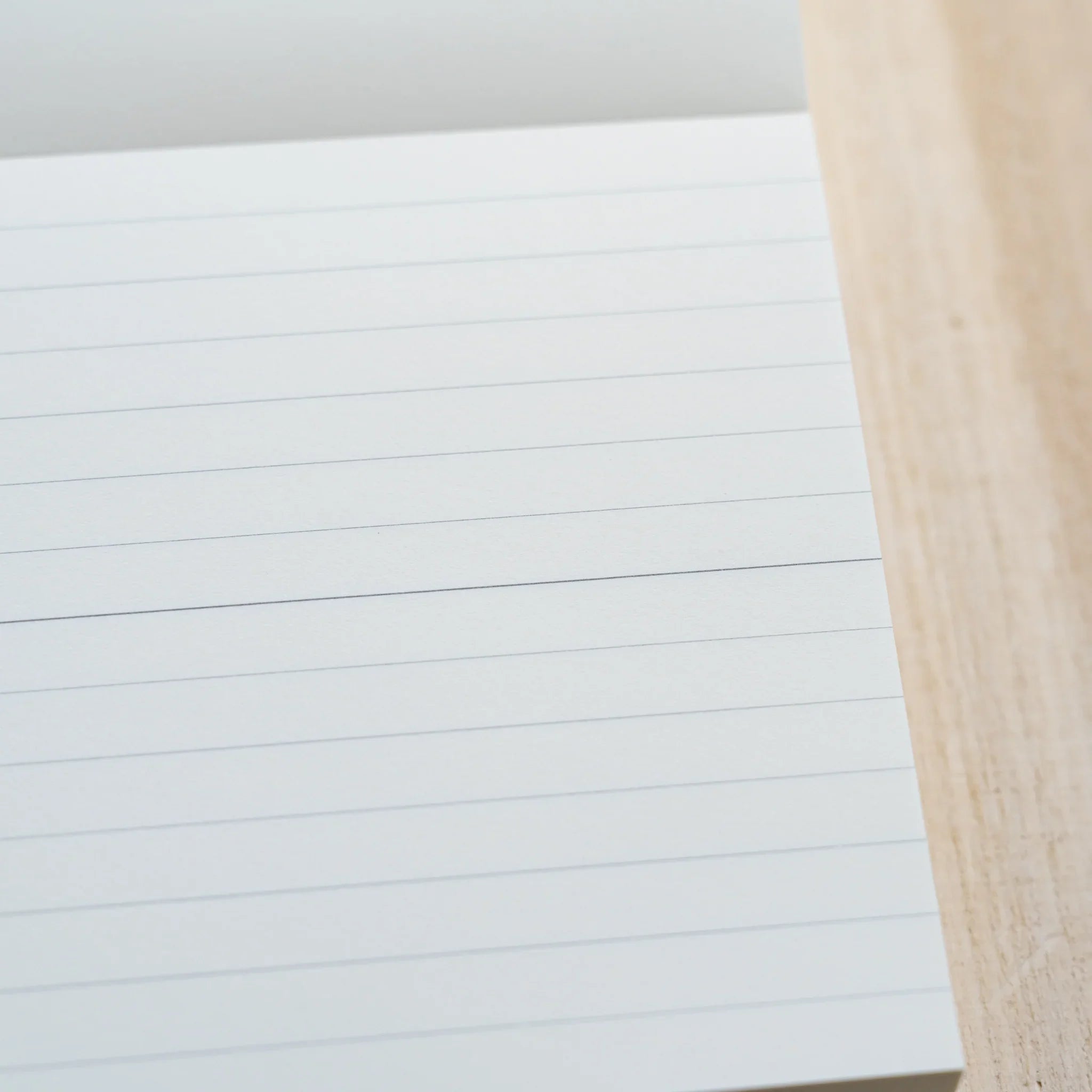 Close-up of an MD Memo Block sheet showing fine horizontal ruled lines on white paper