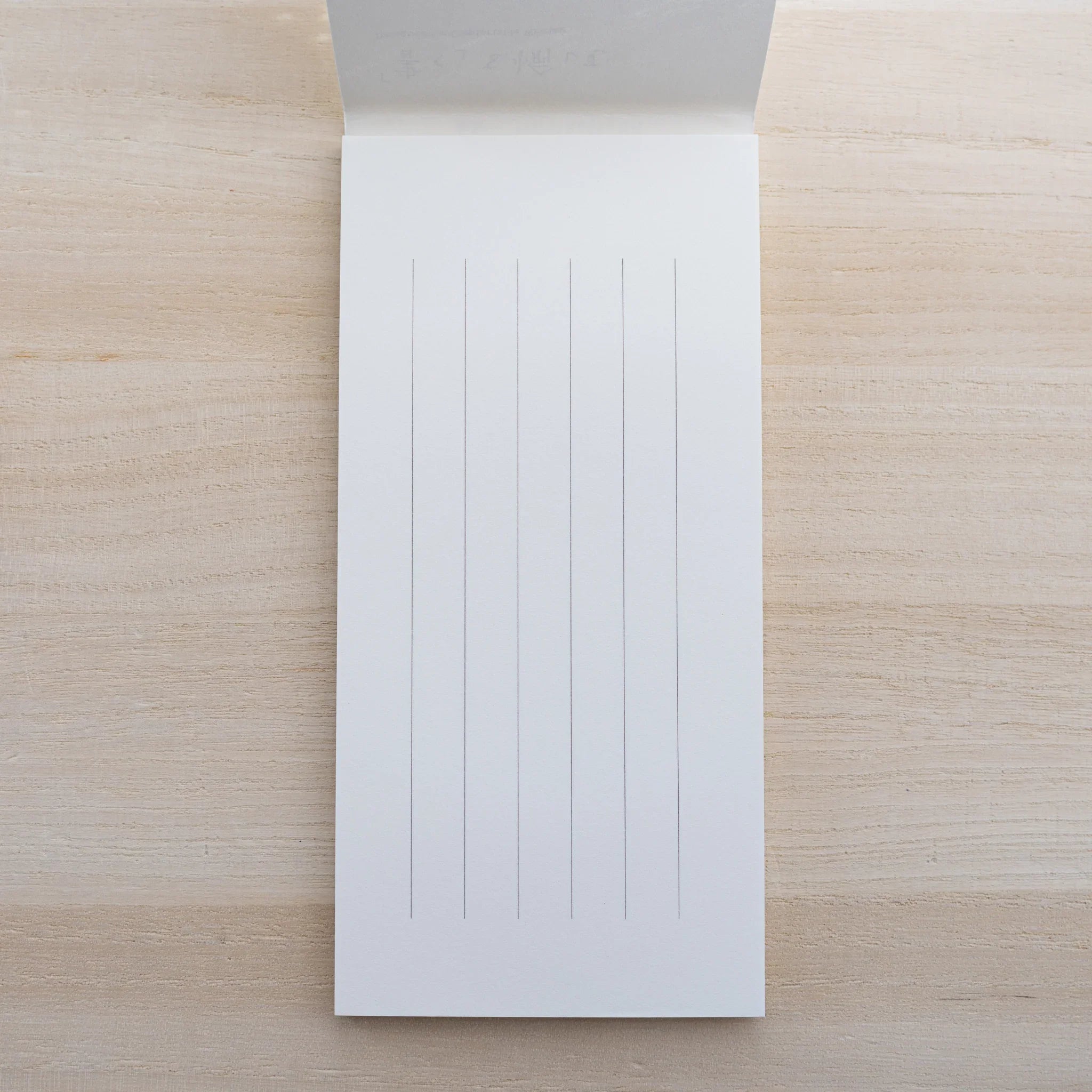 MD Paper Cotton letter pad opened to a sheet with vertical ruled lines on cream paper