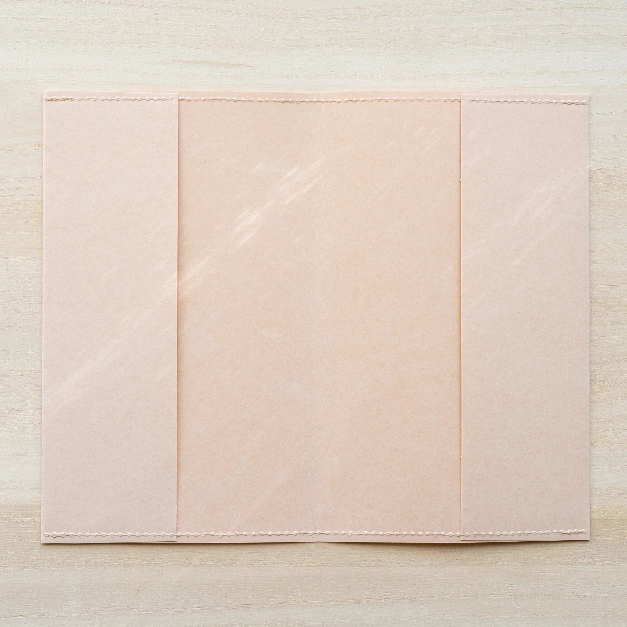 MD Product Paper Notebook Cover for B6 Slim unfolded flat showing peach kraft paper with stitched edges.