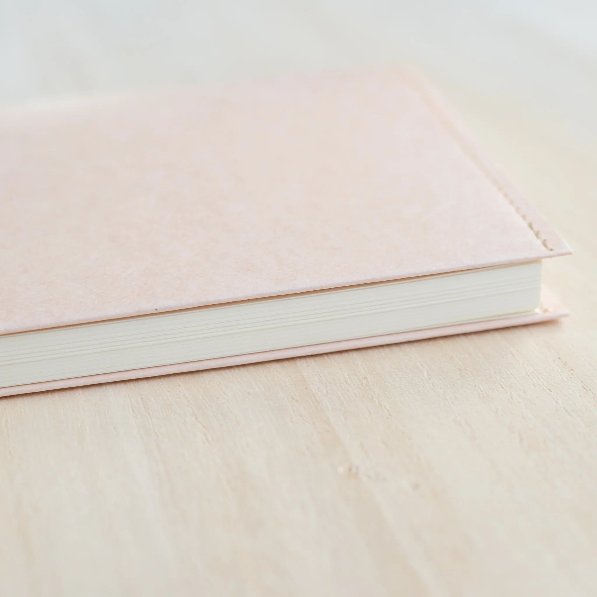 Top-down close-up of MD Product Paper Notebook Cover B6 Slim showing peach kraft paper texture and notebook spine.