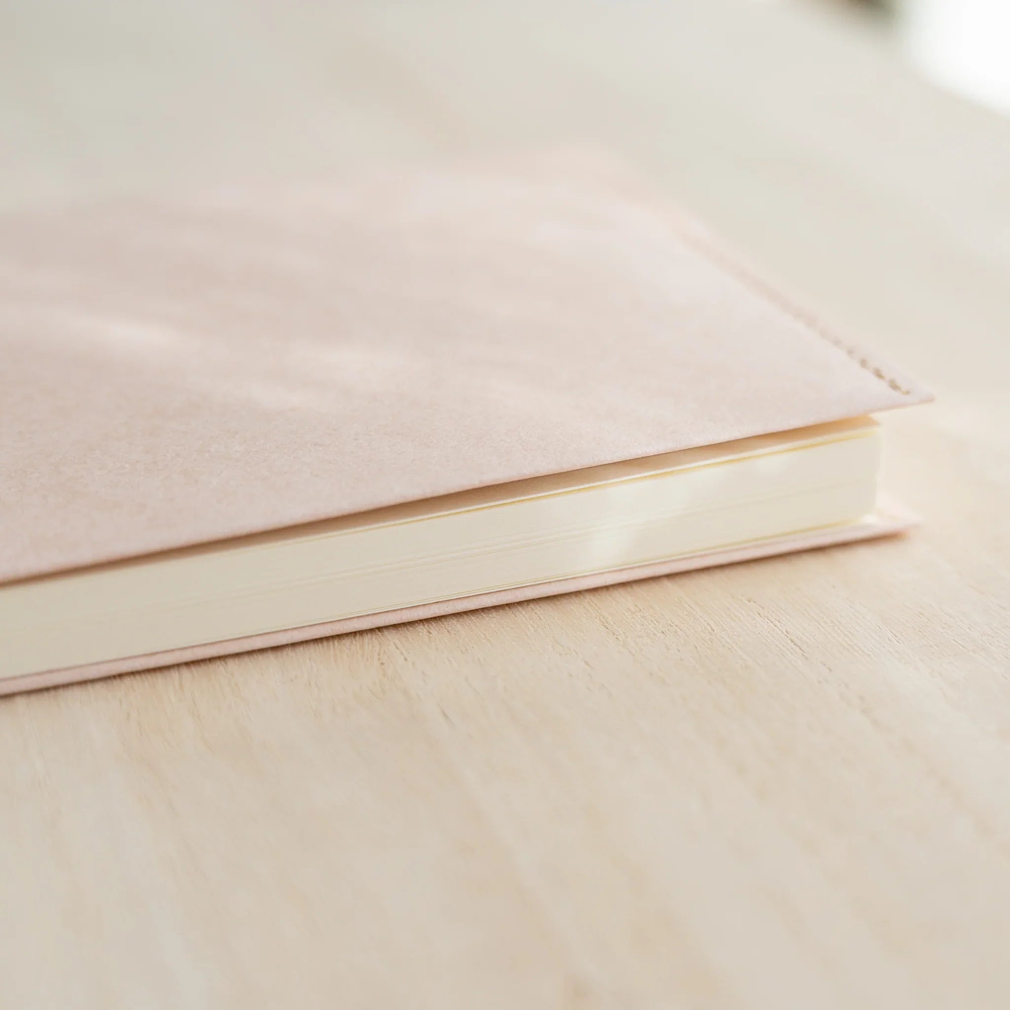 Close-up of a pale pink MD Notebook Paper Cover corner and fold