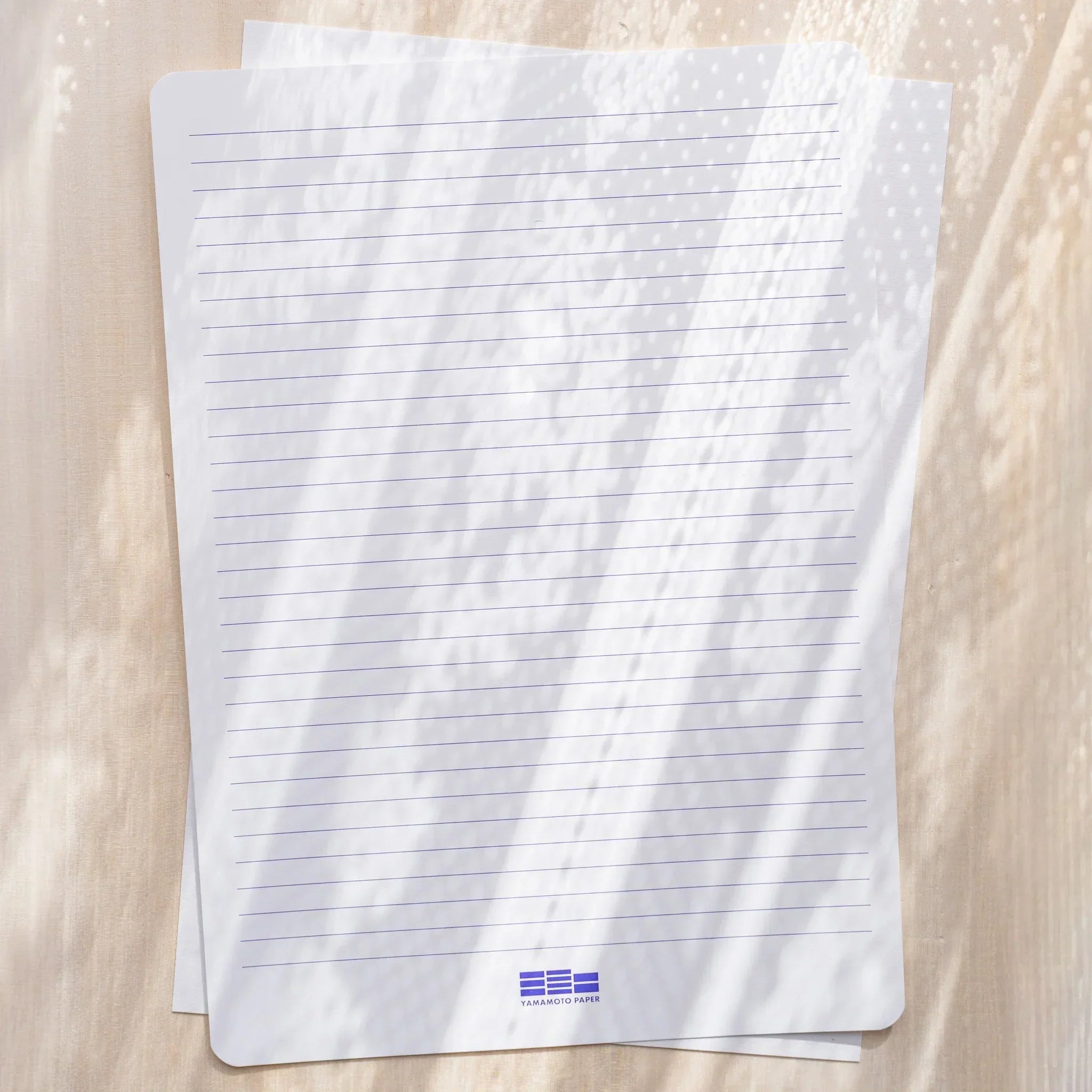 Yamamoto Paper Meringue A4 loose leaf sheet shown with printed horizontal line template overlay.