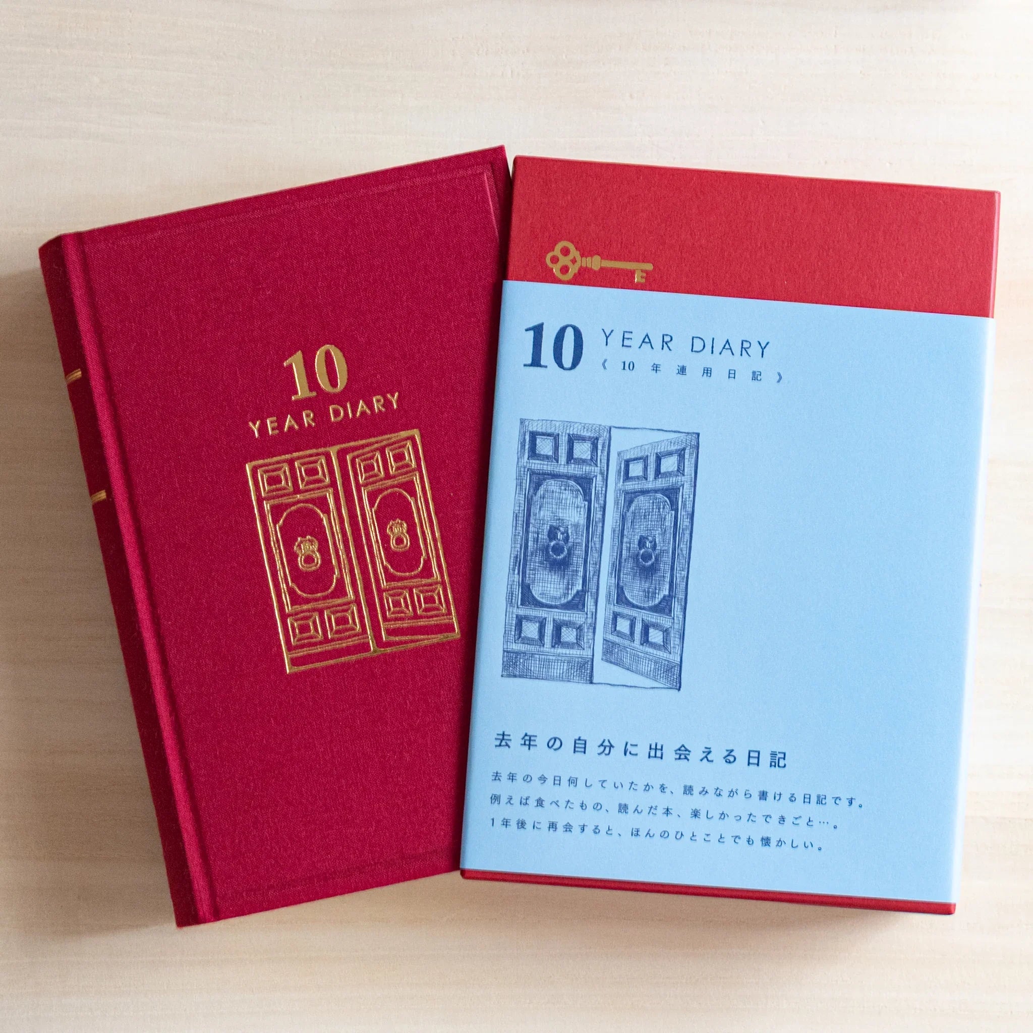 Midori Japanese journal 10-year diary gate design showing red book next to blue slipcase with red top.