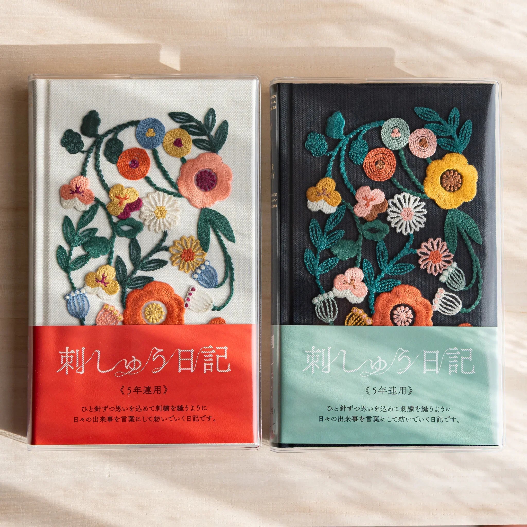 Japanese journal set by Midori with two journals with floral embroidery covers on white and dark background