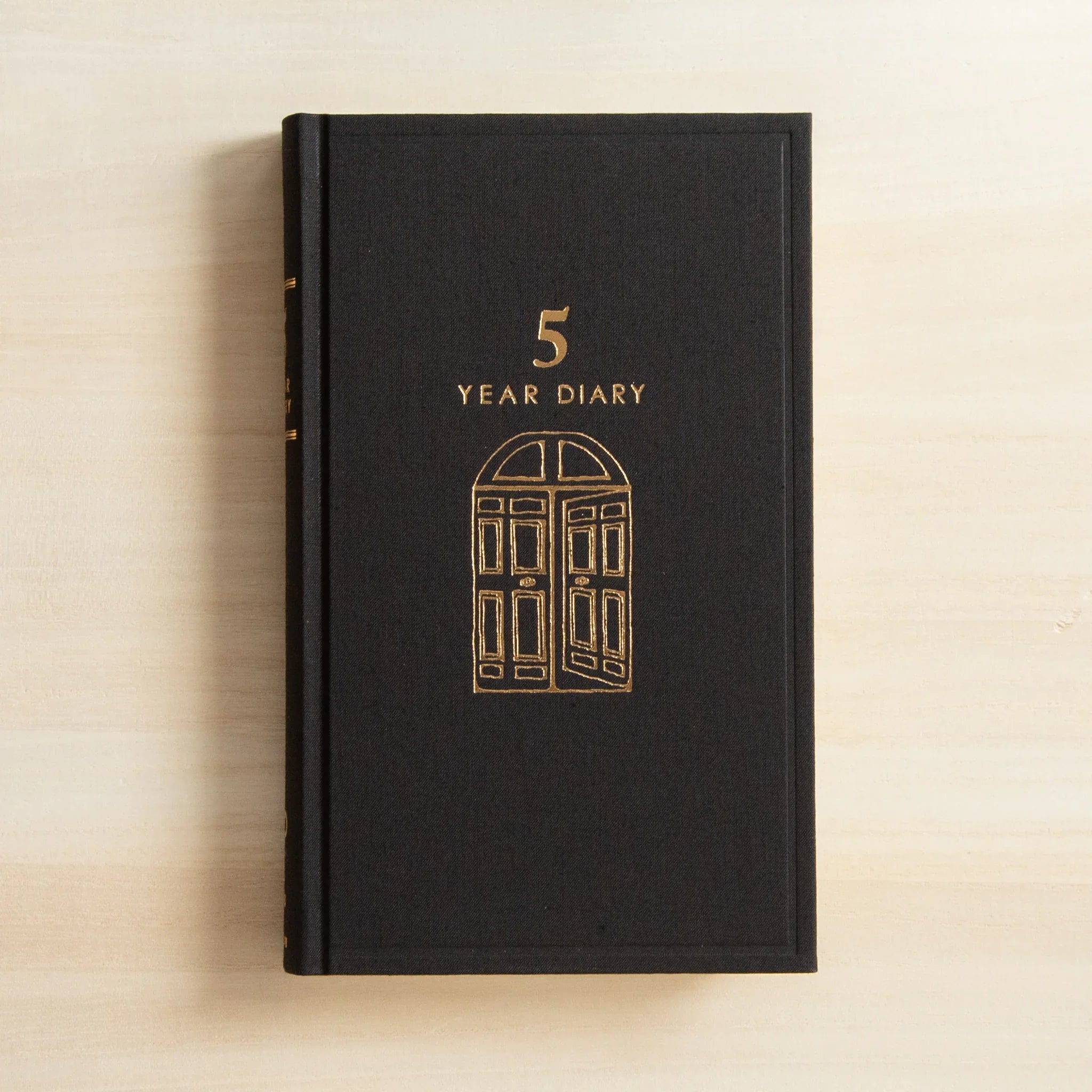 Midori 5 Year Journal Gate Design Japanese Journal black cloth hardcover with gold door artwork centered on the front.