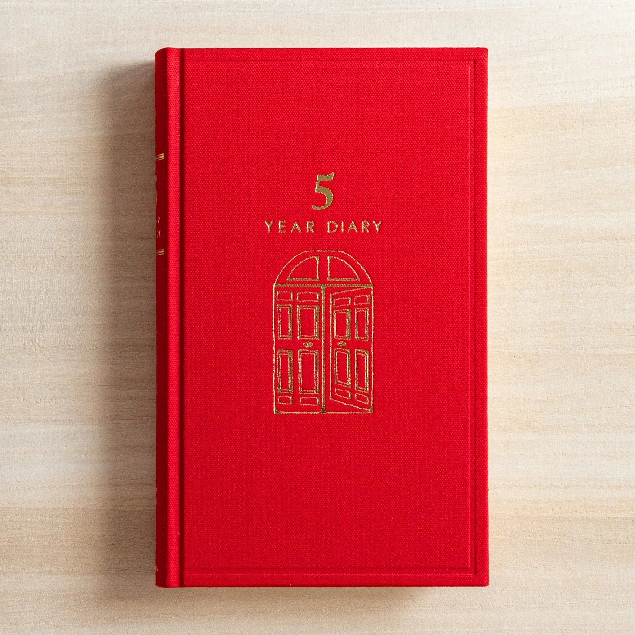 Front view of the red Midori 5 Year Journal Gate Design Japanese Journal with gold foil gate artwork.