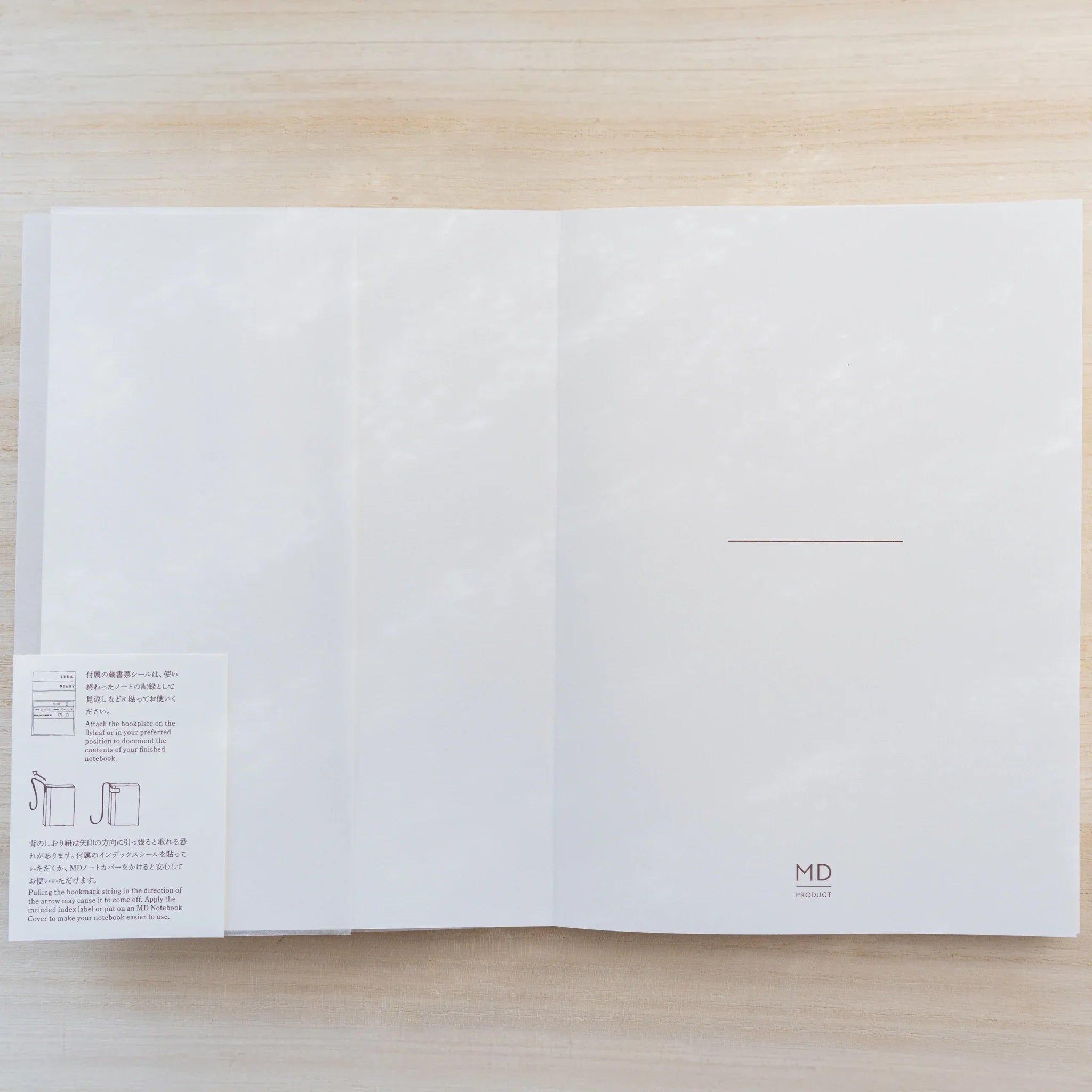 Midori MD Cotton Notebook A5 open flat to inside cover with name line and MD Product logo, instruction leaflet at left