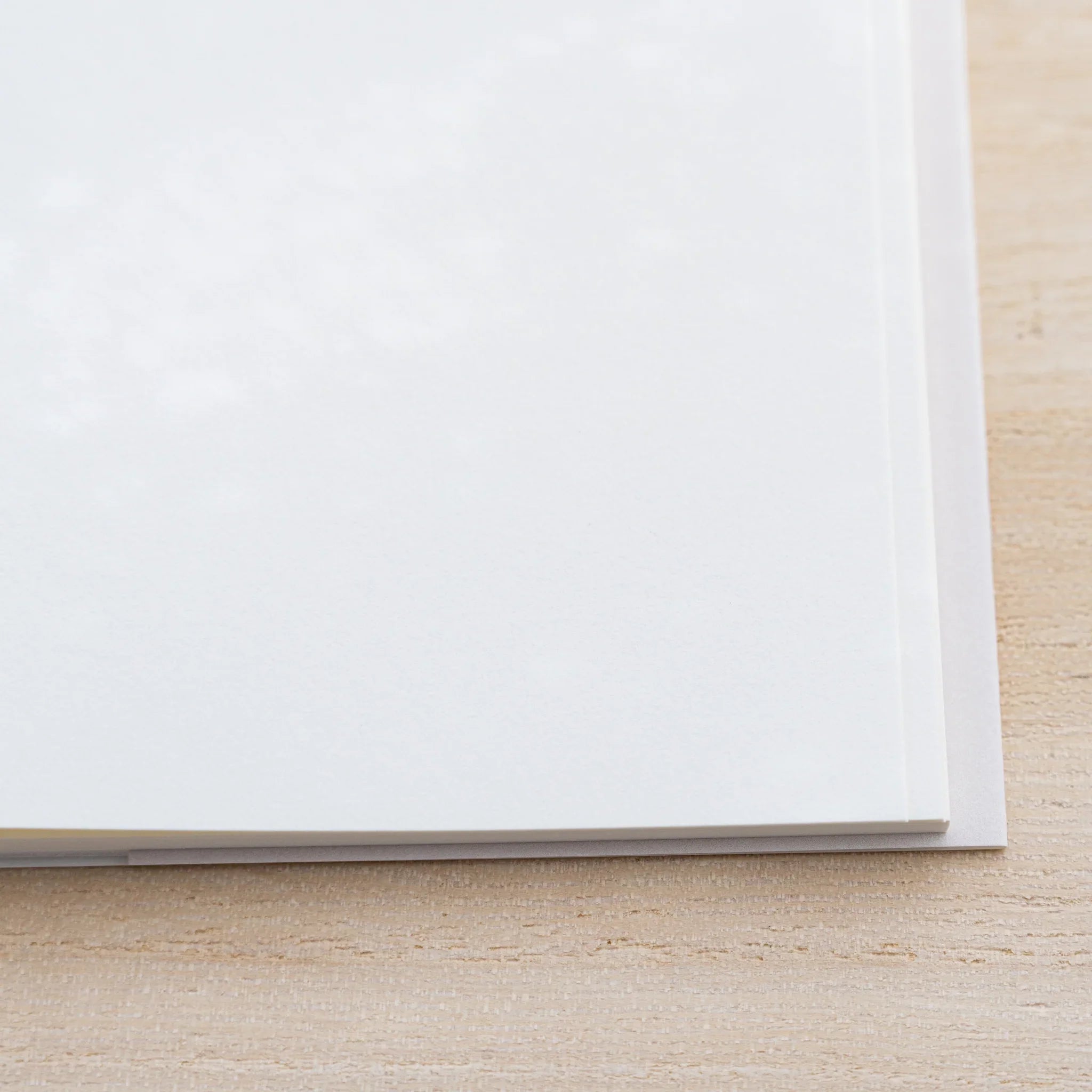 Close-up of Midori MD Cotton Notebook A5 lower edge showing cream pages and the clear glassine cover