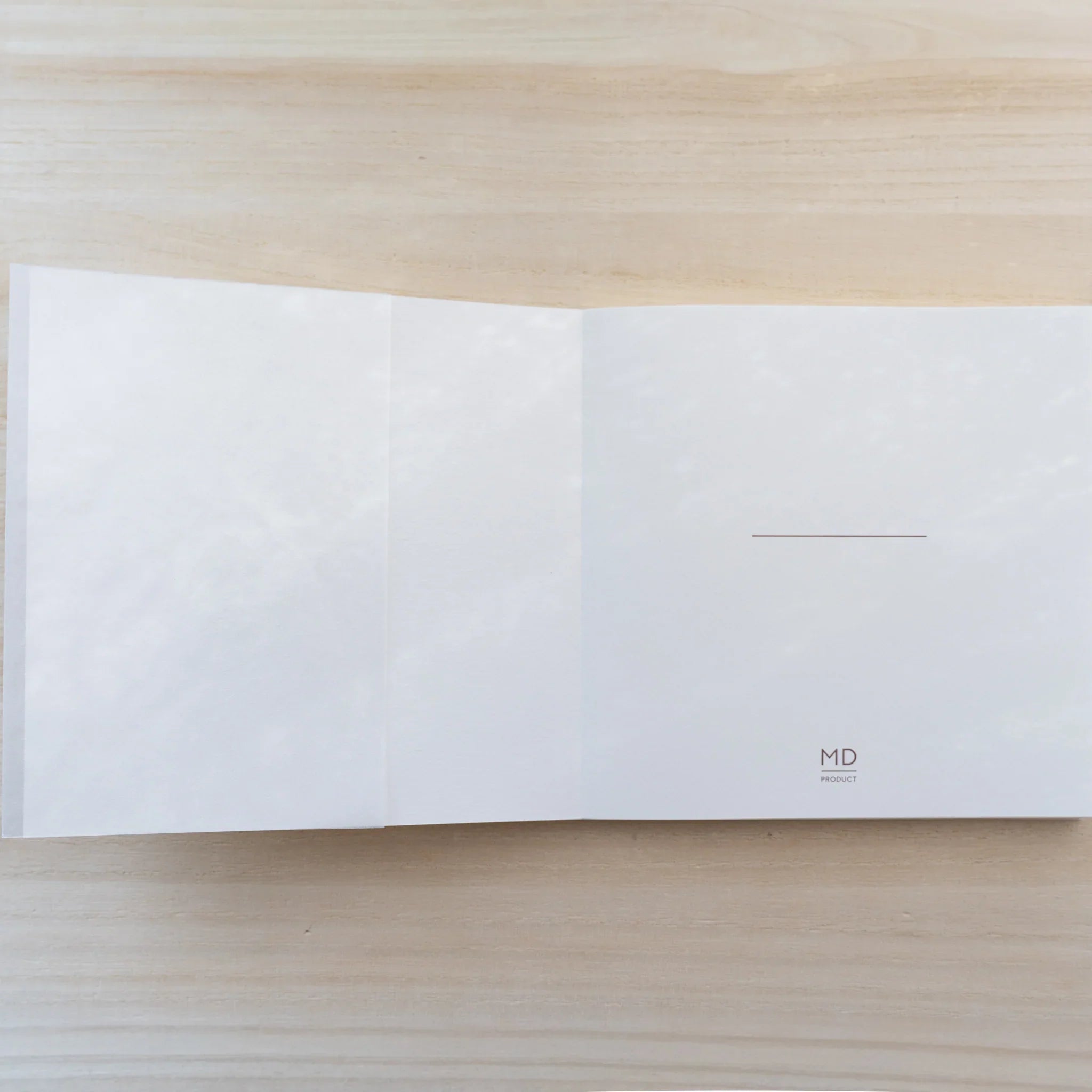 MD Cotton Notebook A5 Square opened flat showing a blank cream square spread with small MD logo