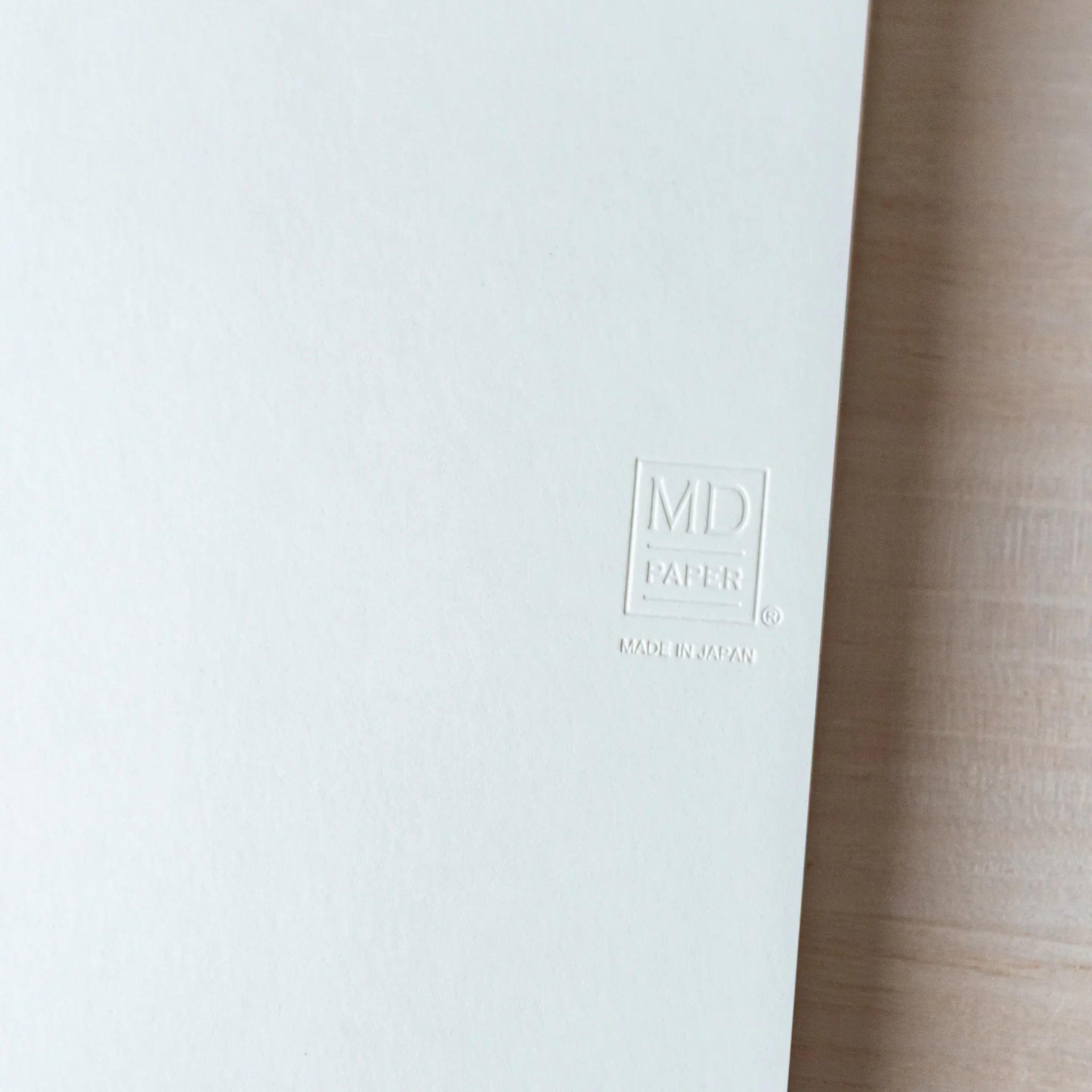Japanese Notebook Midori MD A6 cover close-up, showing the embossed MD PAPER logo.