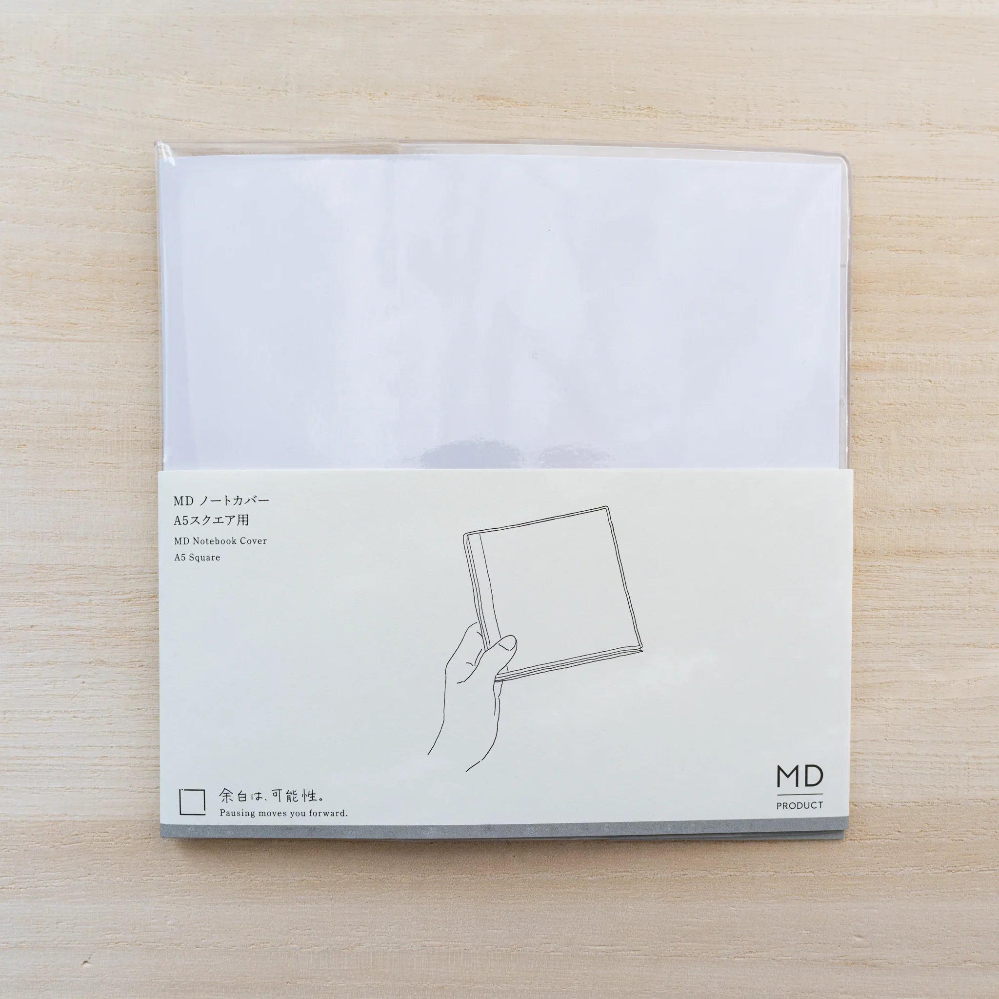Insert card for Midori MD Notebook Cover A5 Square with hand holding a square notebook and MD logo
