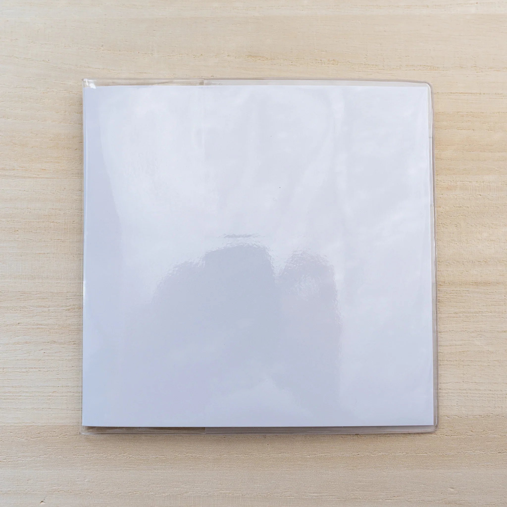 Square clear PVC Midori MD Notebook Cover A5 Square on a white notebook, closed front view