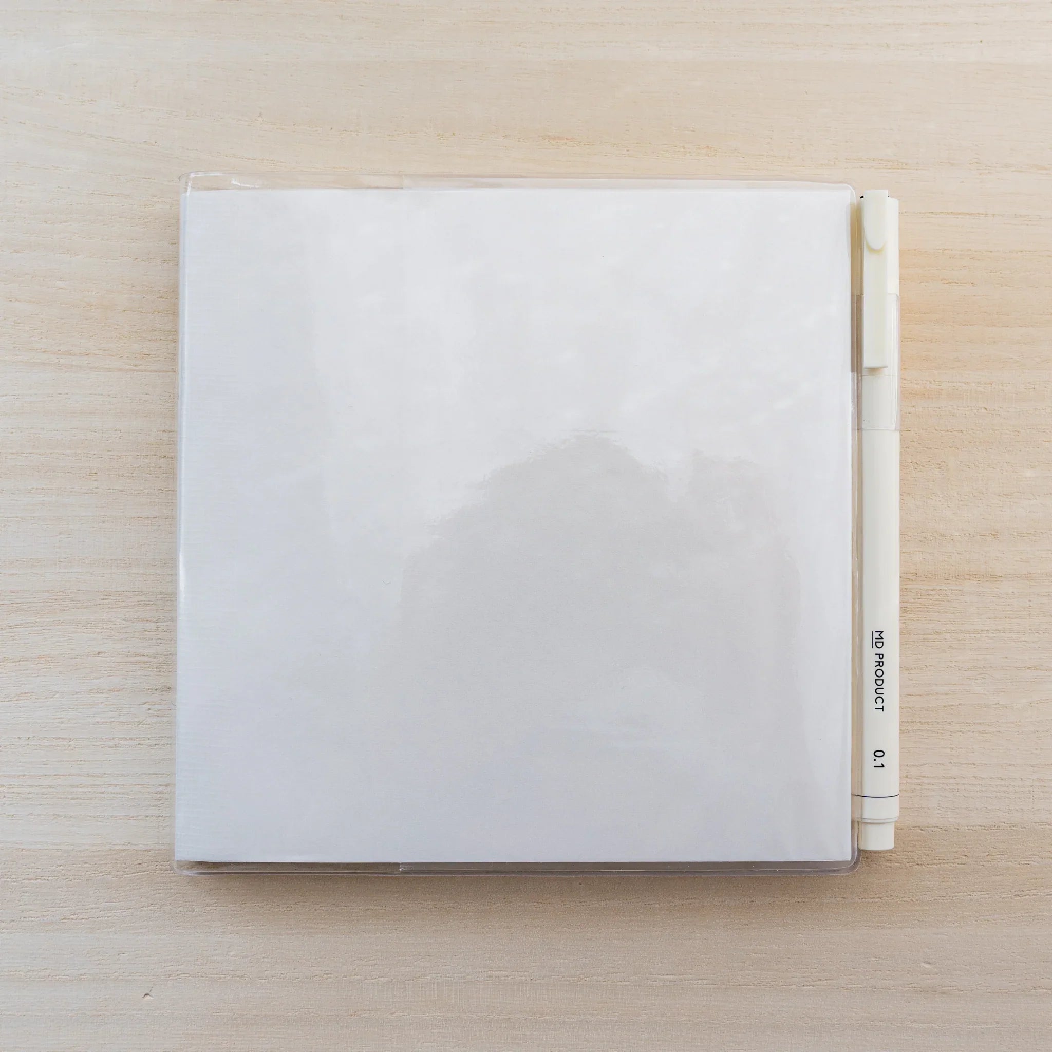 MD Notebook Cover A5 Square opened flat in clear PVC, blank white square spread with center fold