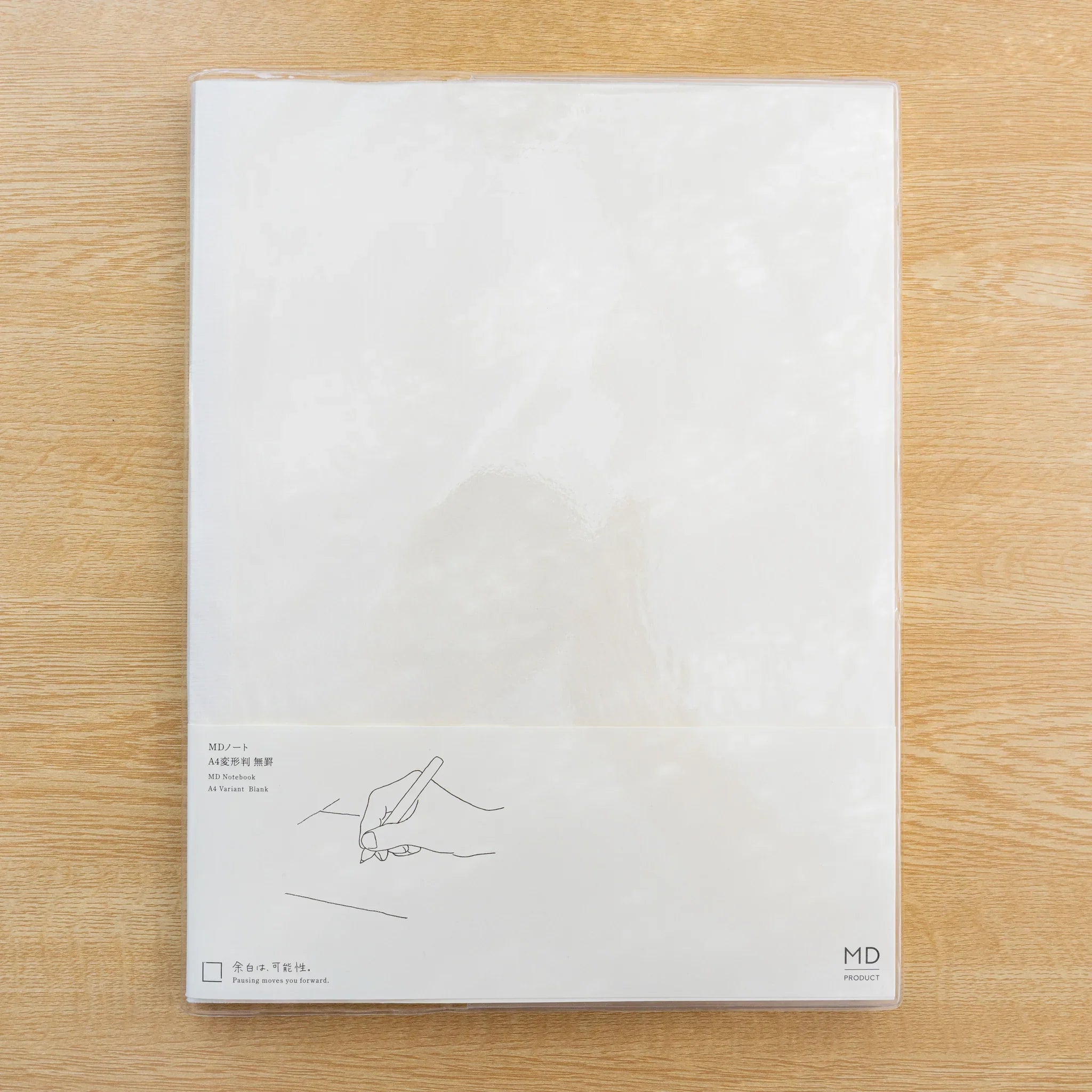 Back of Midori MD Notebook Cover A4 Variant package, clear PVC with pen line drawing and MD PRODUCT logo