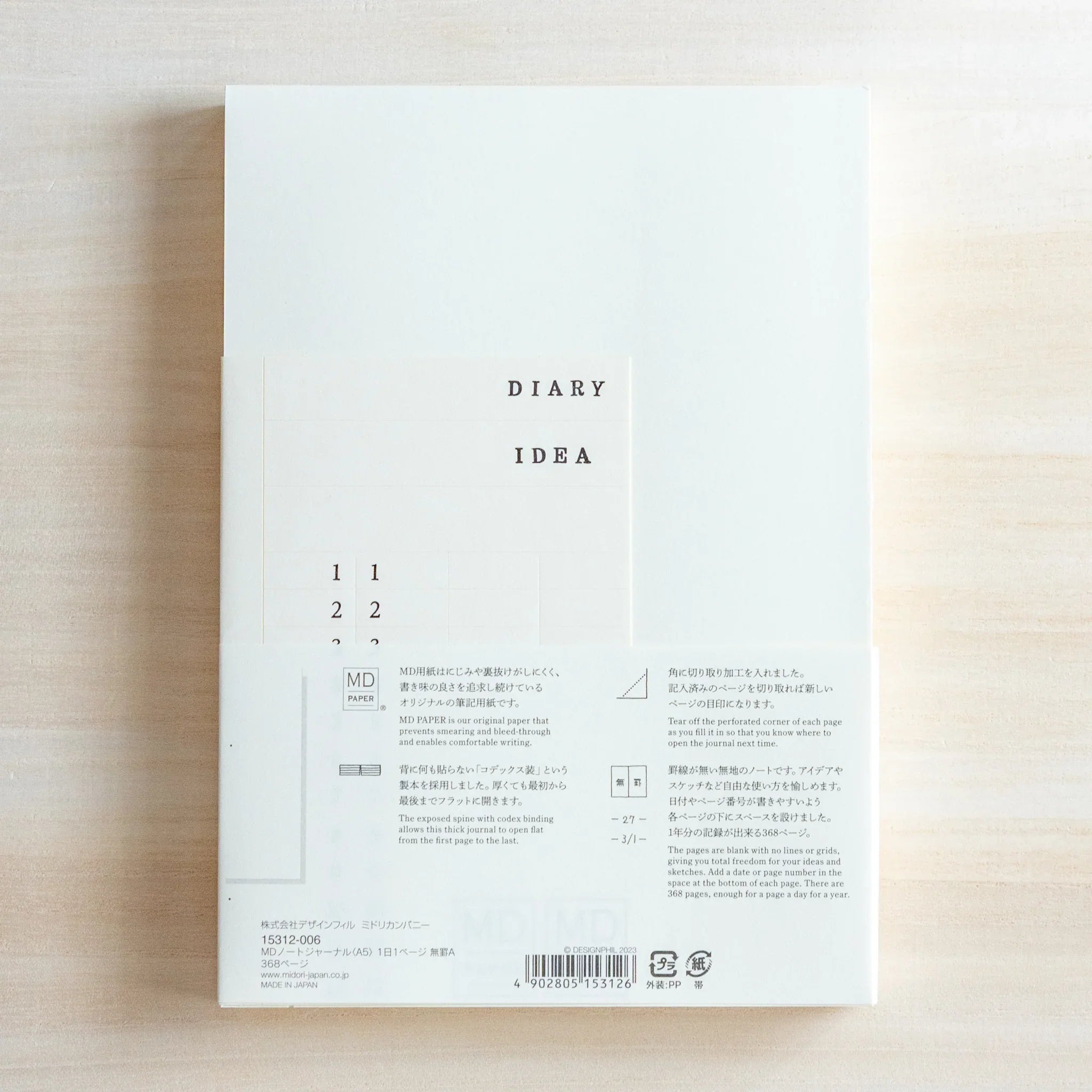 Top view of Midori Japanese journal packaging labeled DIARY IDEA with numbers and diagram on cream background.