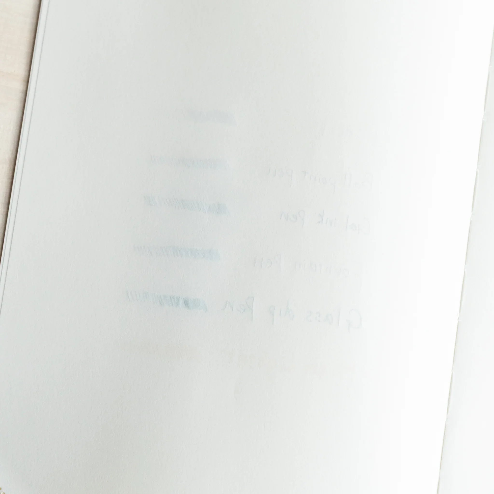 Backside of Midori MD Paper Thick notebook showing light bleed-through from fountain pens and other writing tools
