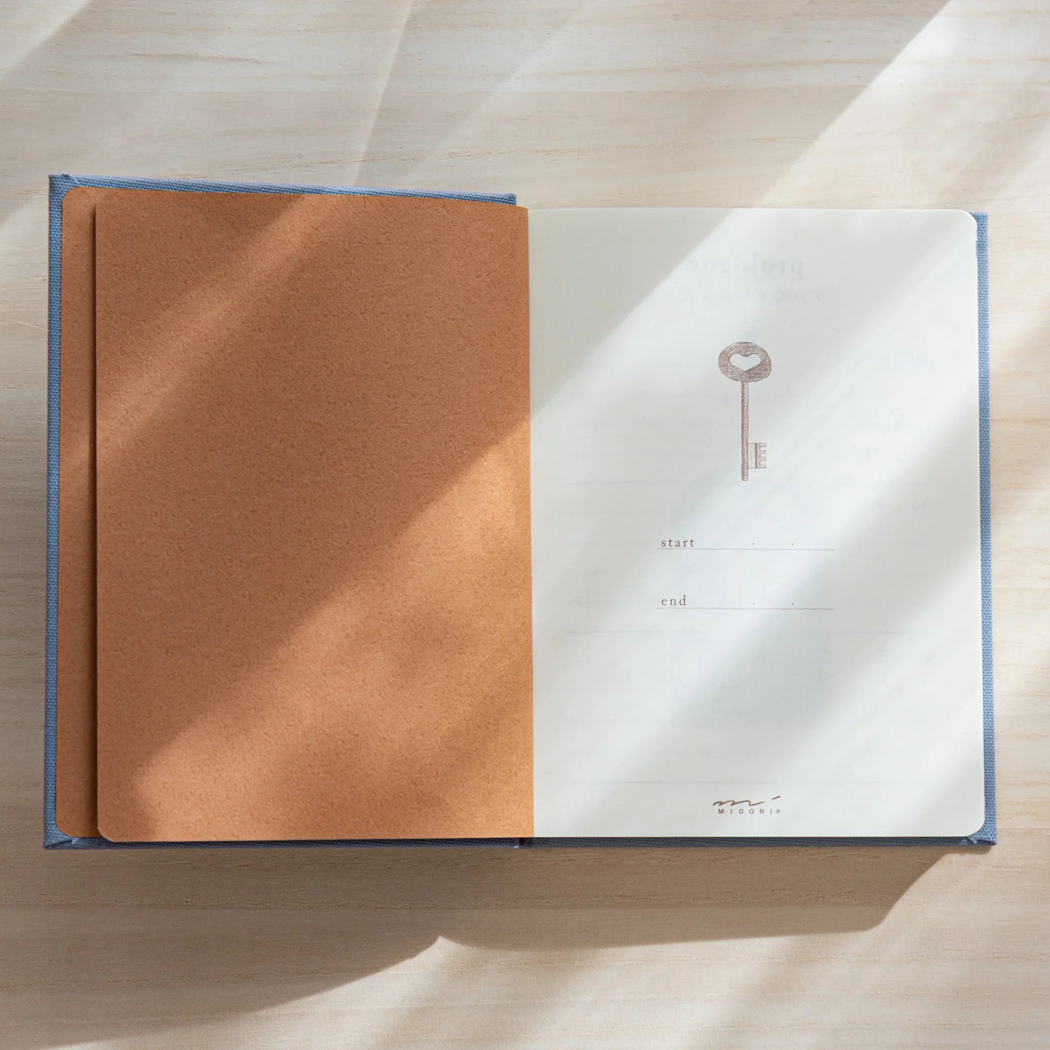 Japanese journal Midori 3-year diary open showing brown inside cover and first page with key illustration