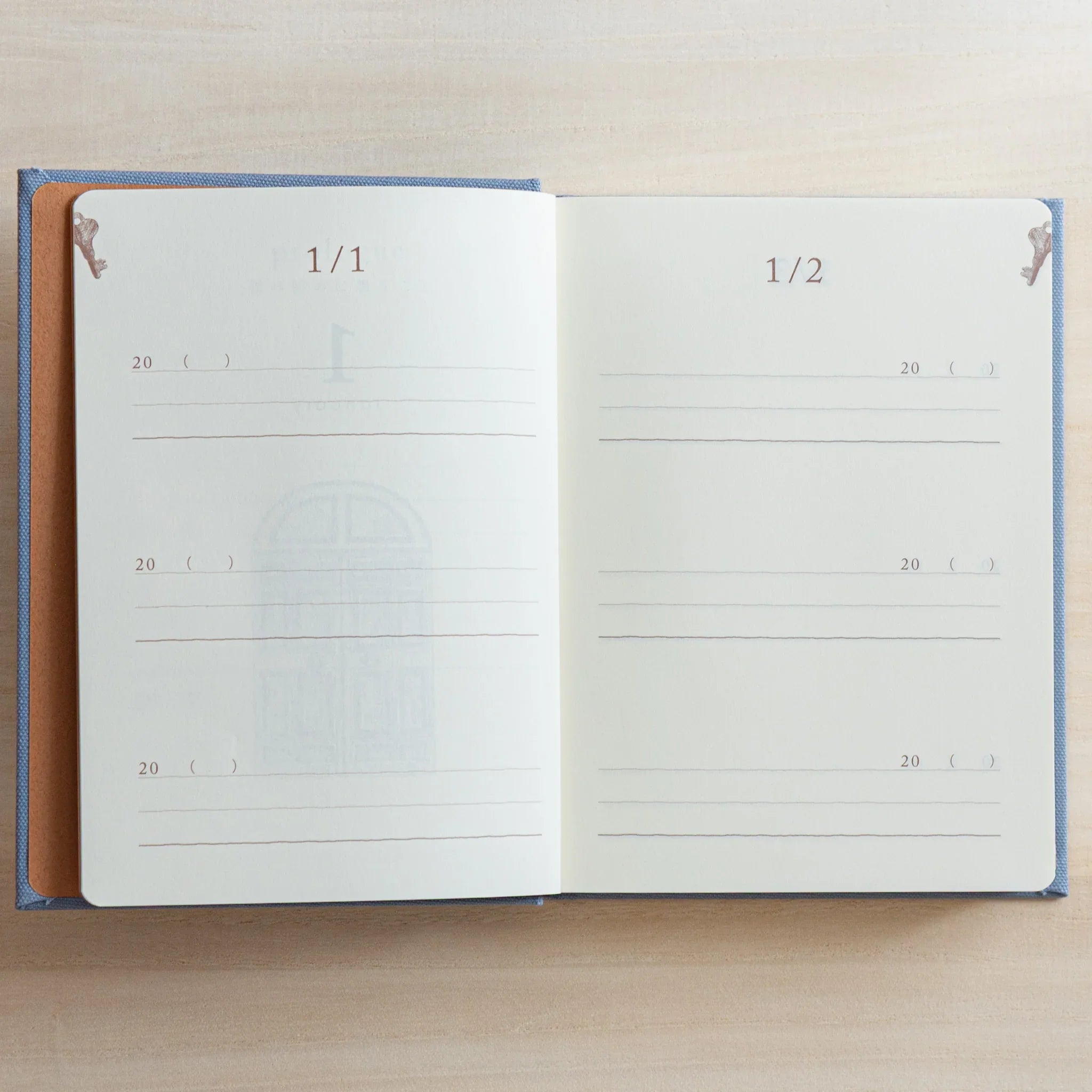 Japanese journal Midori 3-year diary open to January 1/1 and 1/2 pages with lined sections and small gate and bird motifs.