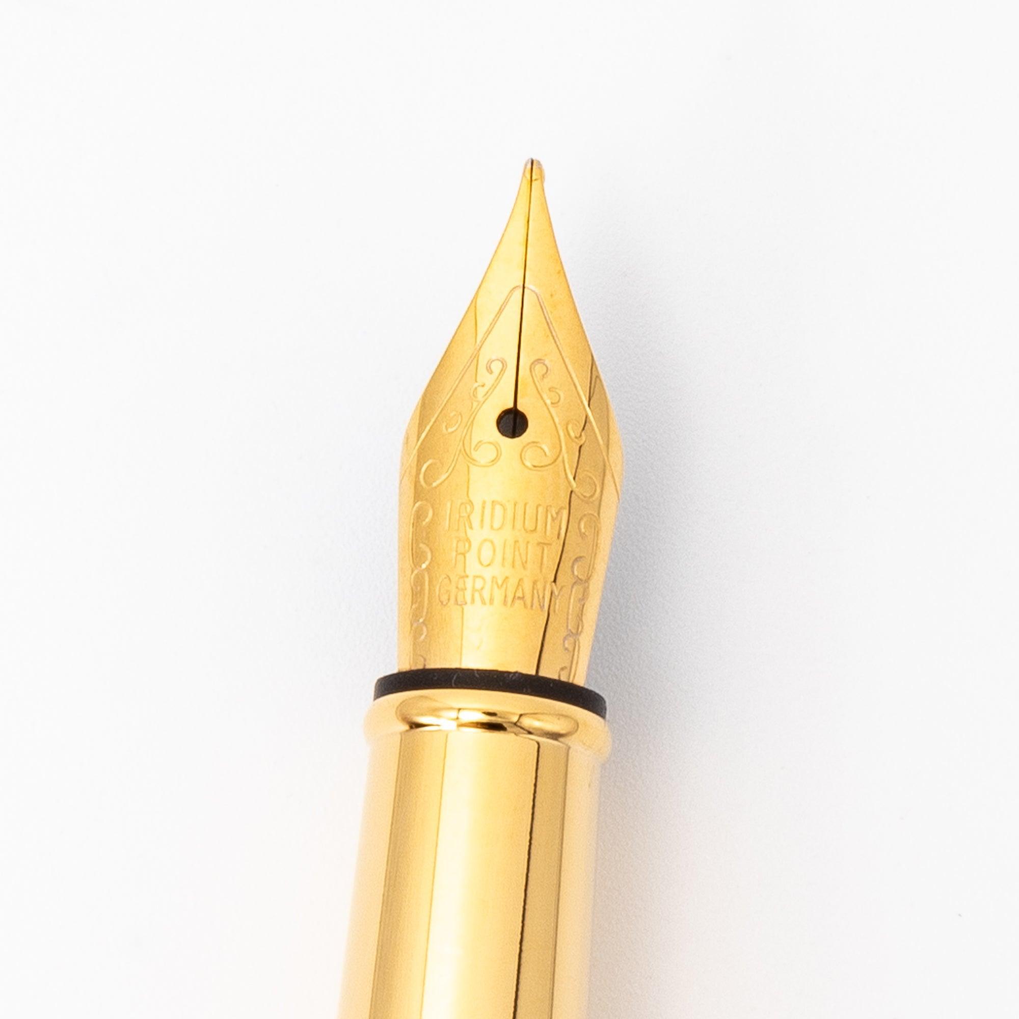 A close-up of a Japanese fountain pen’s gold nib with intricate engravings, emphasizing its elegance and attention to detail in design.  