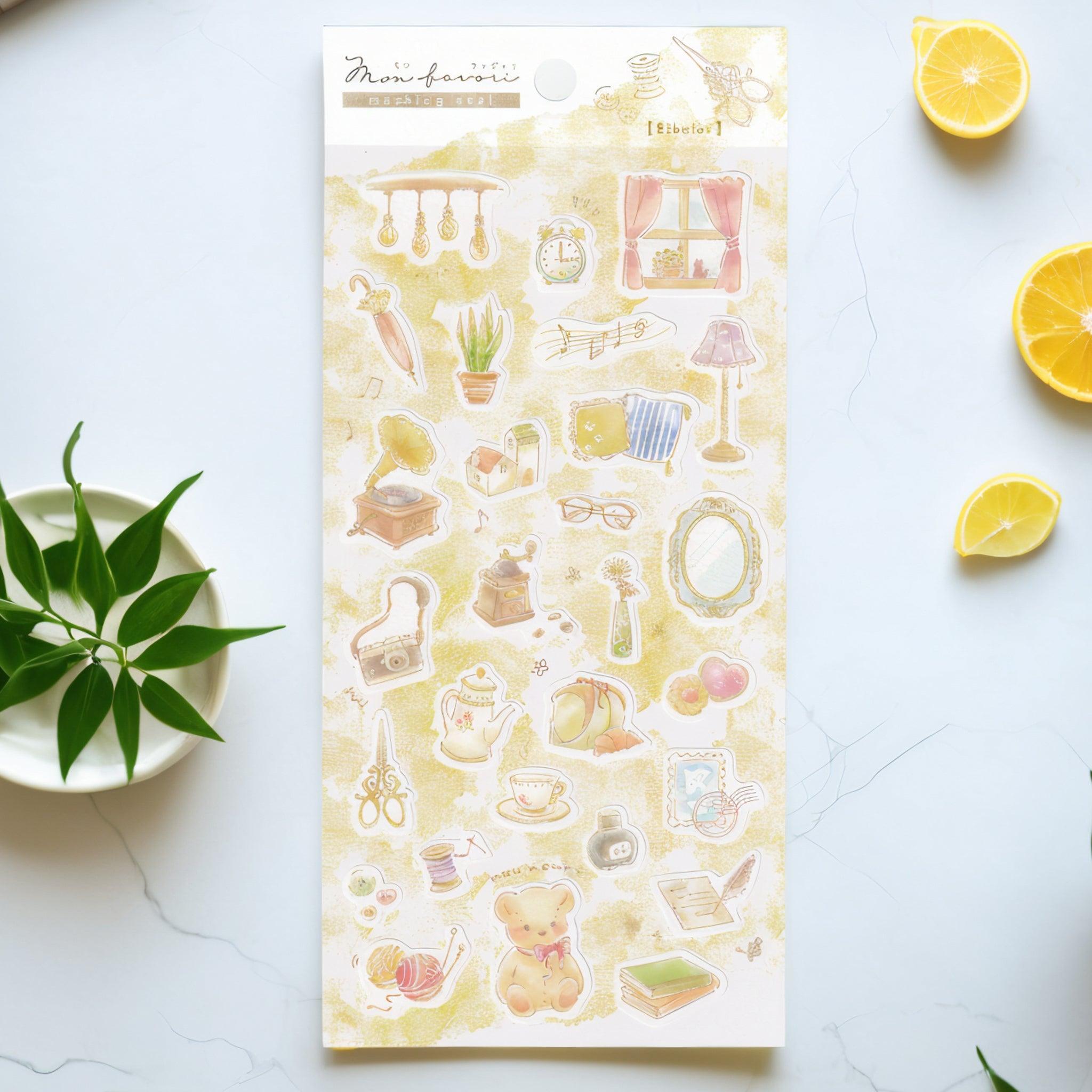 A Japanese stationery washi sticker sheet featuring cozy vintage-inspired designs, including books, teacups, sewing tools, plants, and a teddy bear, in soft watercolor style.