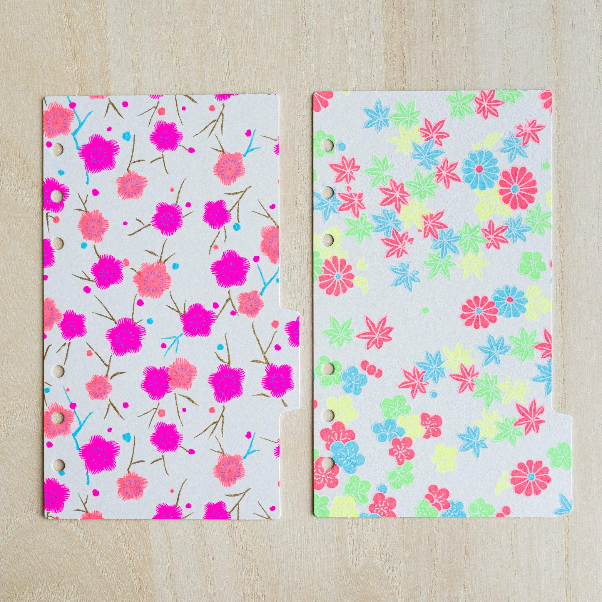 Two neon index dividers side by side, magenta plum blossom print and multicolor maple leaf print on washi