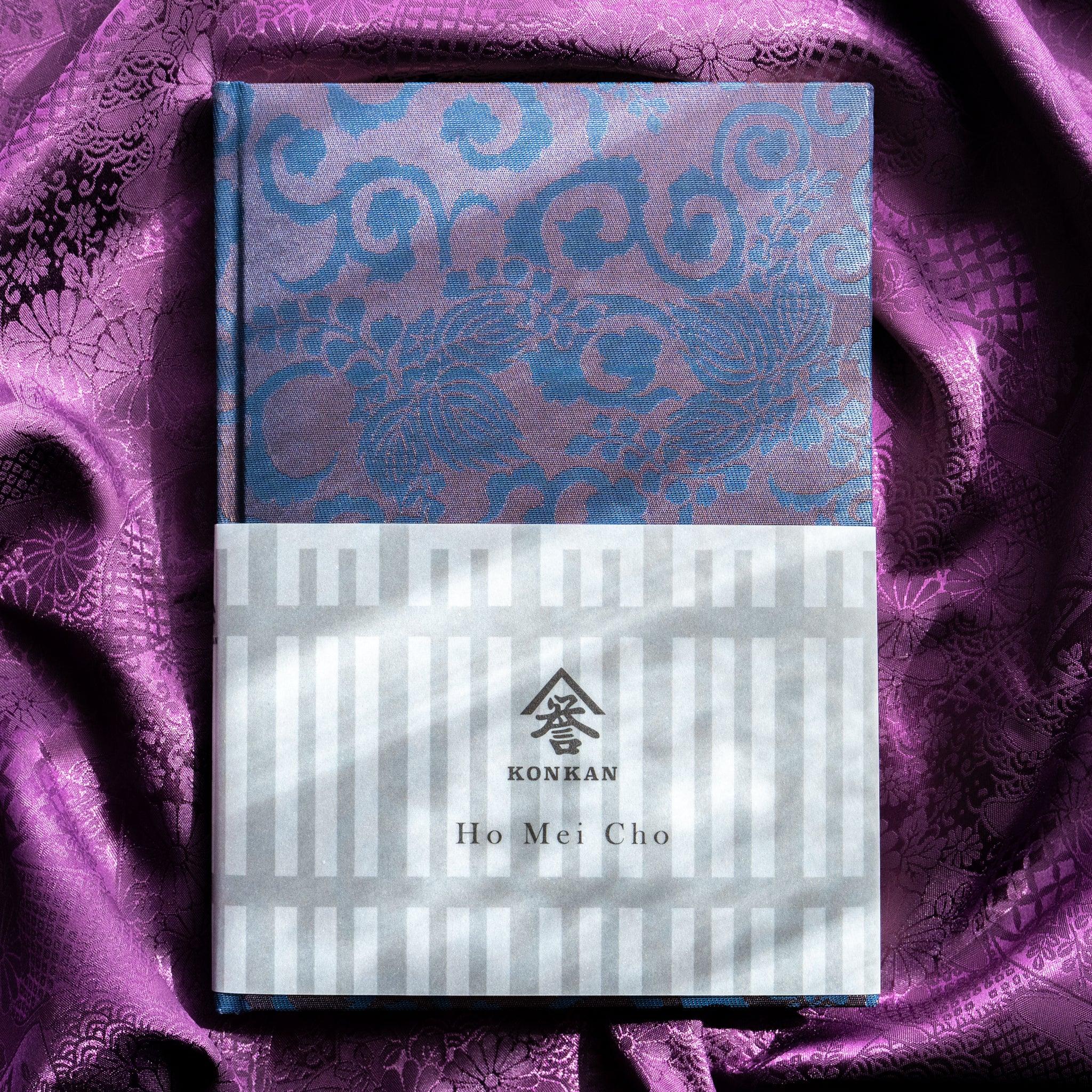 Oni Kiri Nishijin silk Homeicho notebook with KONKAN Ho Mei Cho paper band on purple fabric