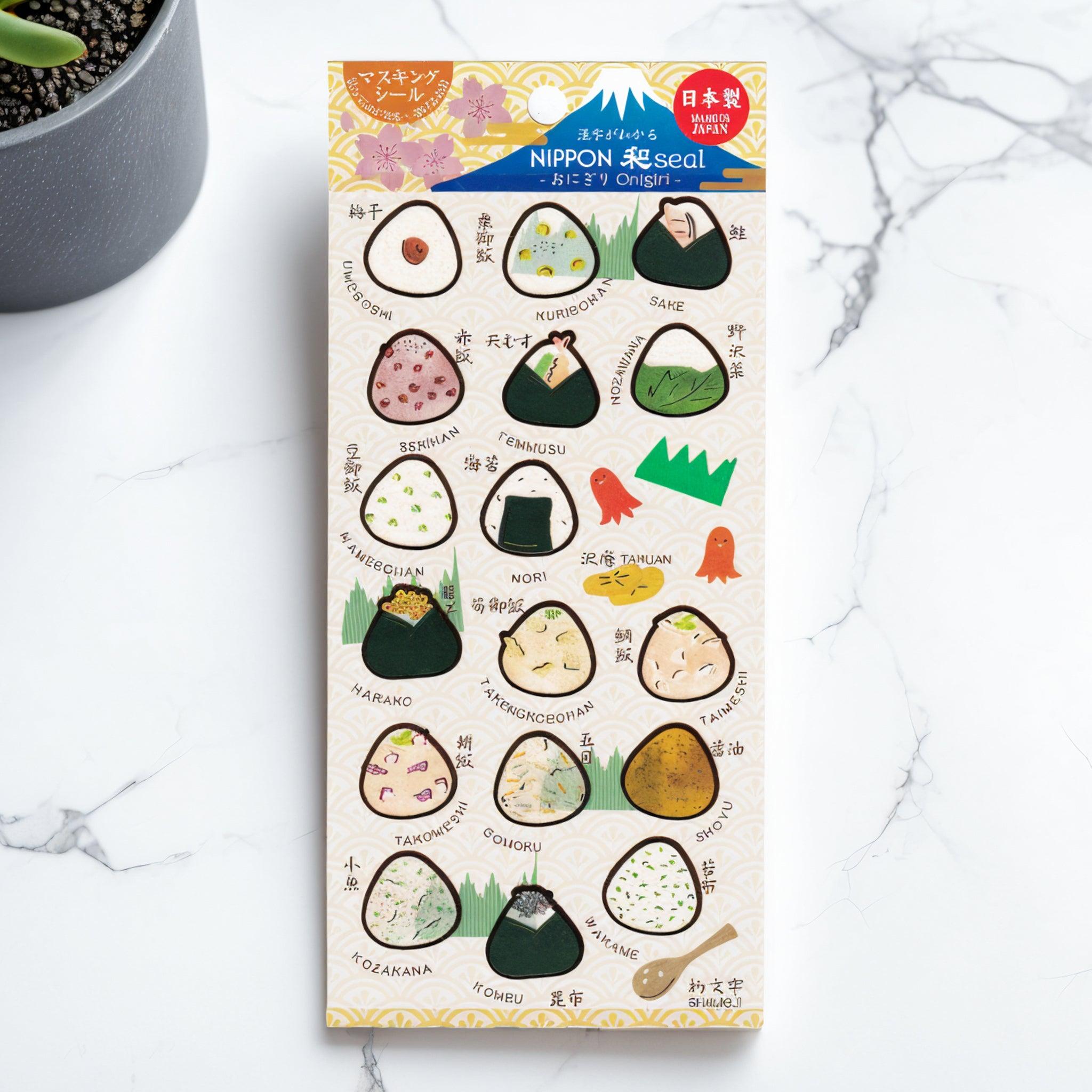 A Japanese stationery washi sticker sheet featuring adorable onigiri designs, showcasing various fillings like salmon, umeboshi, nori, and takikomi gohan, with charming illustrations.