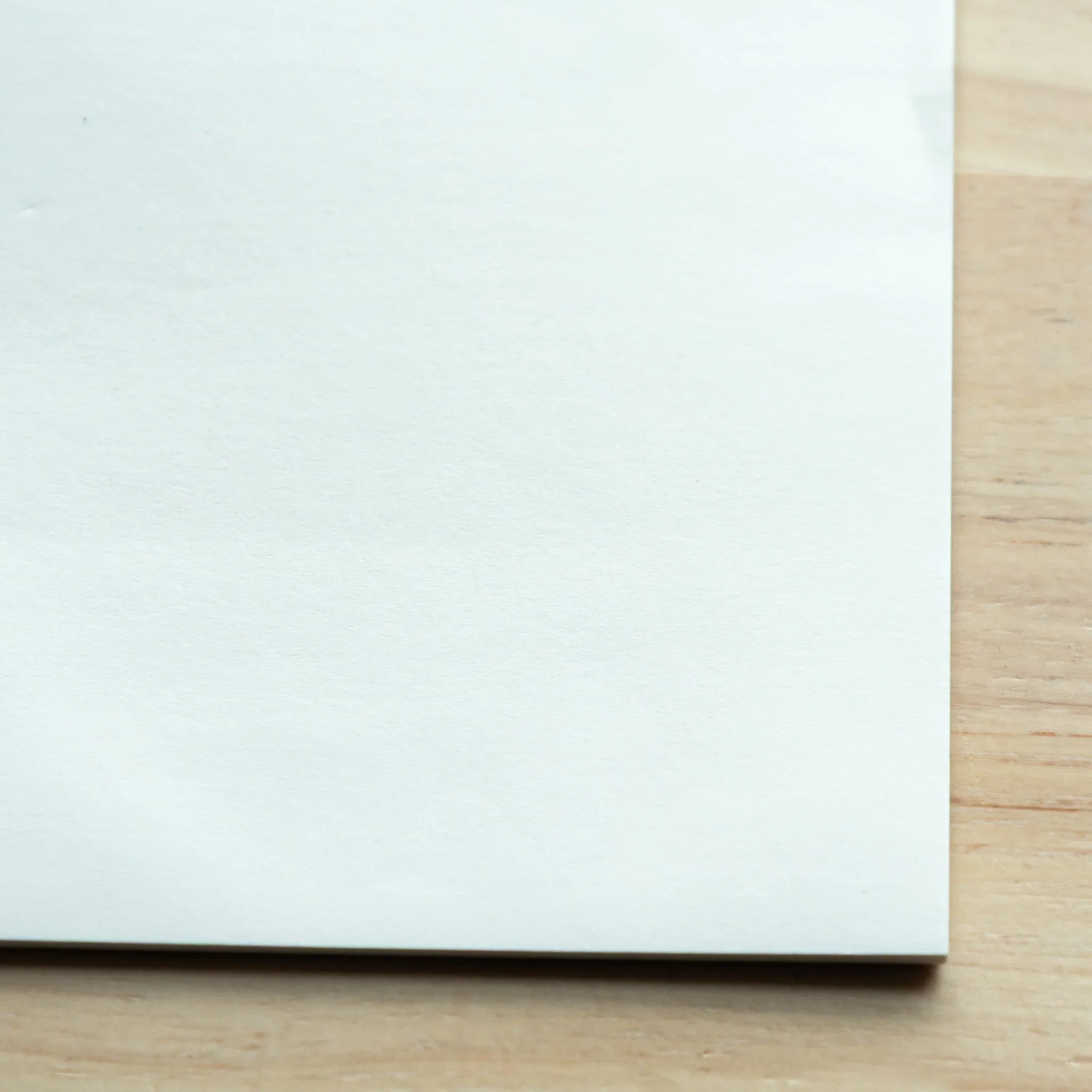 Close-up of blank B6 Sanzen Tomoe River S sheet from Yamamoto Paper Tasting Pad, smooth Japanese Note Book paper surface.