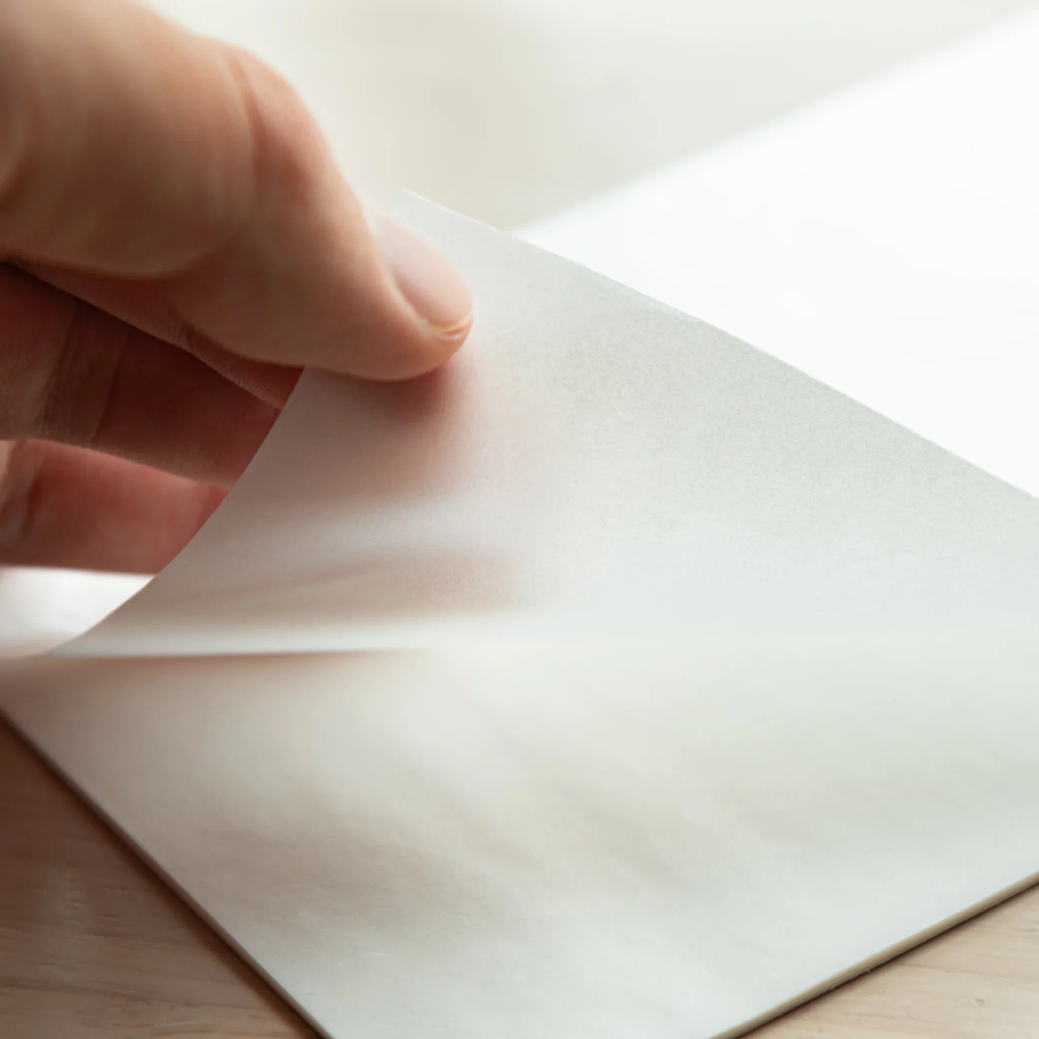 Hand lifting B6 Glassine sheet from Paper Tasting Writing Pad Set Japanese Translucent Paper vol.2, Japanese Note Book sample.