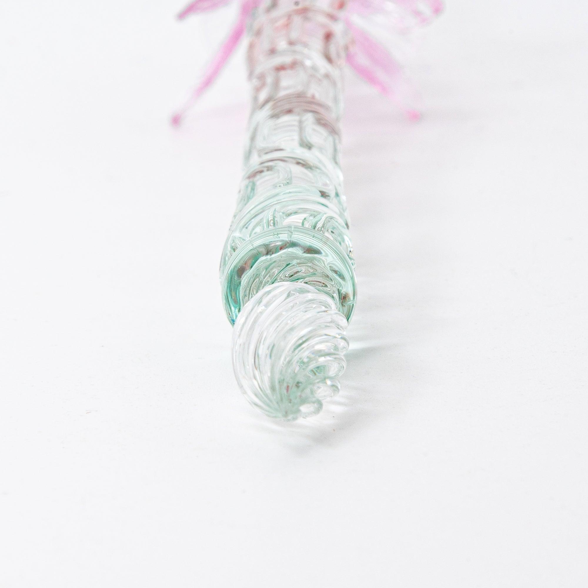 The pink goldfish glass pen photographed on a white background, displaying the clear glass body and the intricately sculpted goldfish in pink glass at the top.