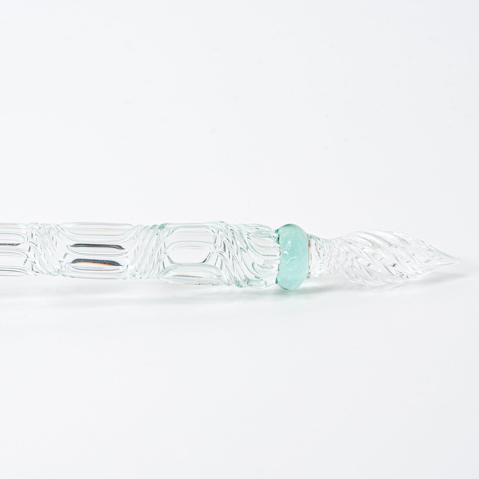 The pink goldfish glass pen photographed on a white background, displaying the clear glass body and the intricately sculpted goldfish in pink glass at the top.