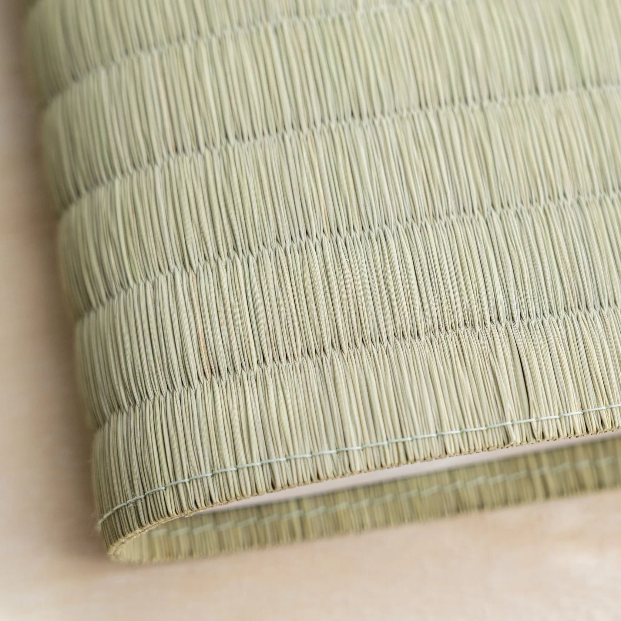 Close-up of the woven green rush straw surface and stitched edge of the Red Imperial Chrysanthemum tatami book cover