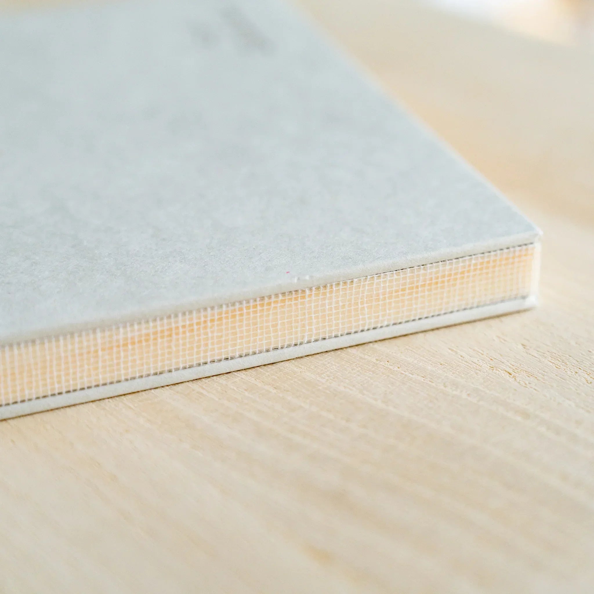 Red Pine wood-paged B6 notebook, overhead photograph with neutral composition and natural lighting showing natural wood