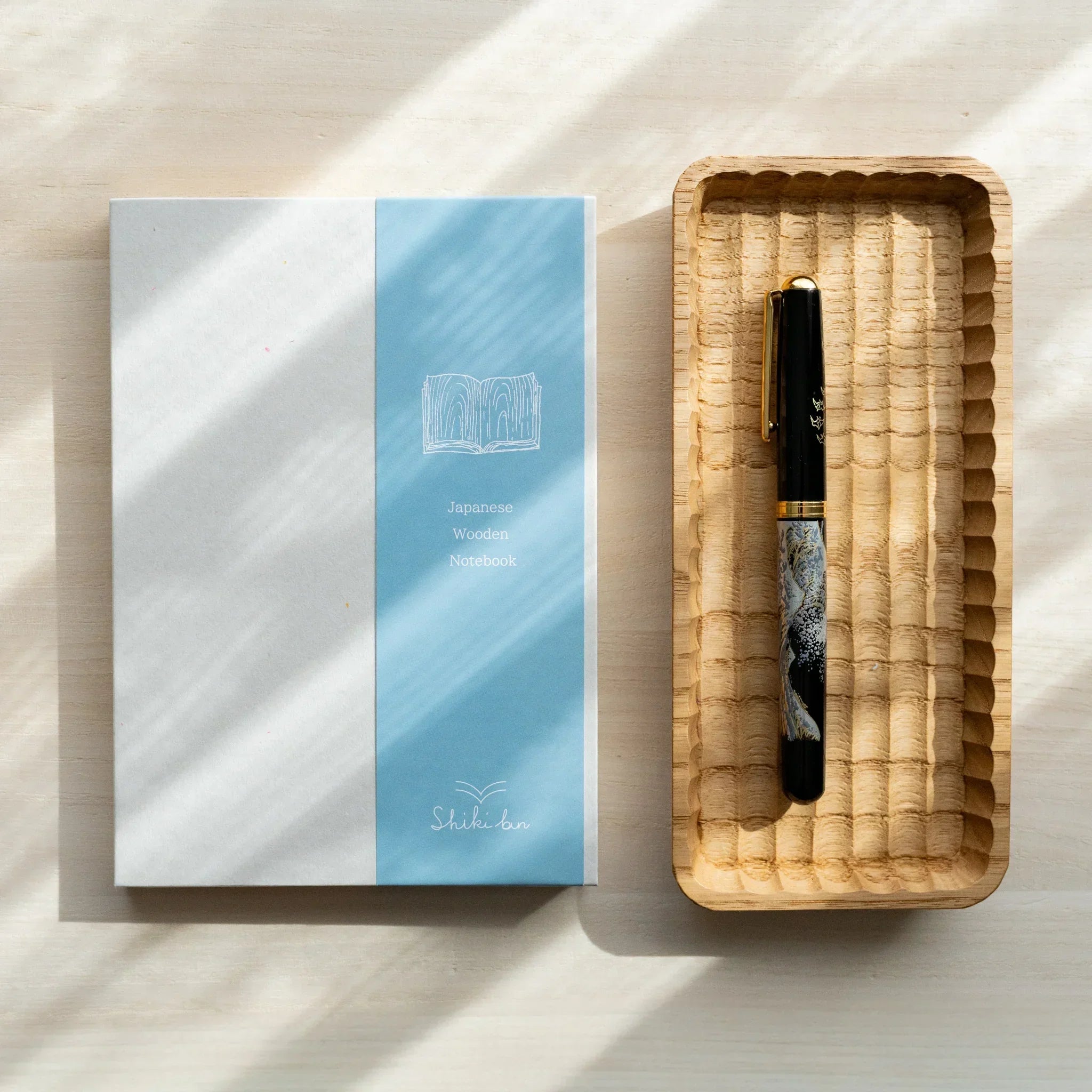Red Pine wood-paged B6 journal, spine showing traditional Japanese construction and natural wood grain