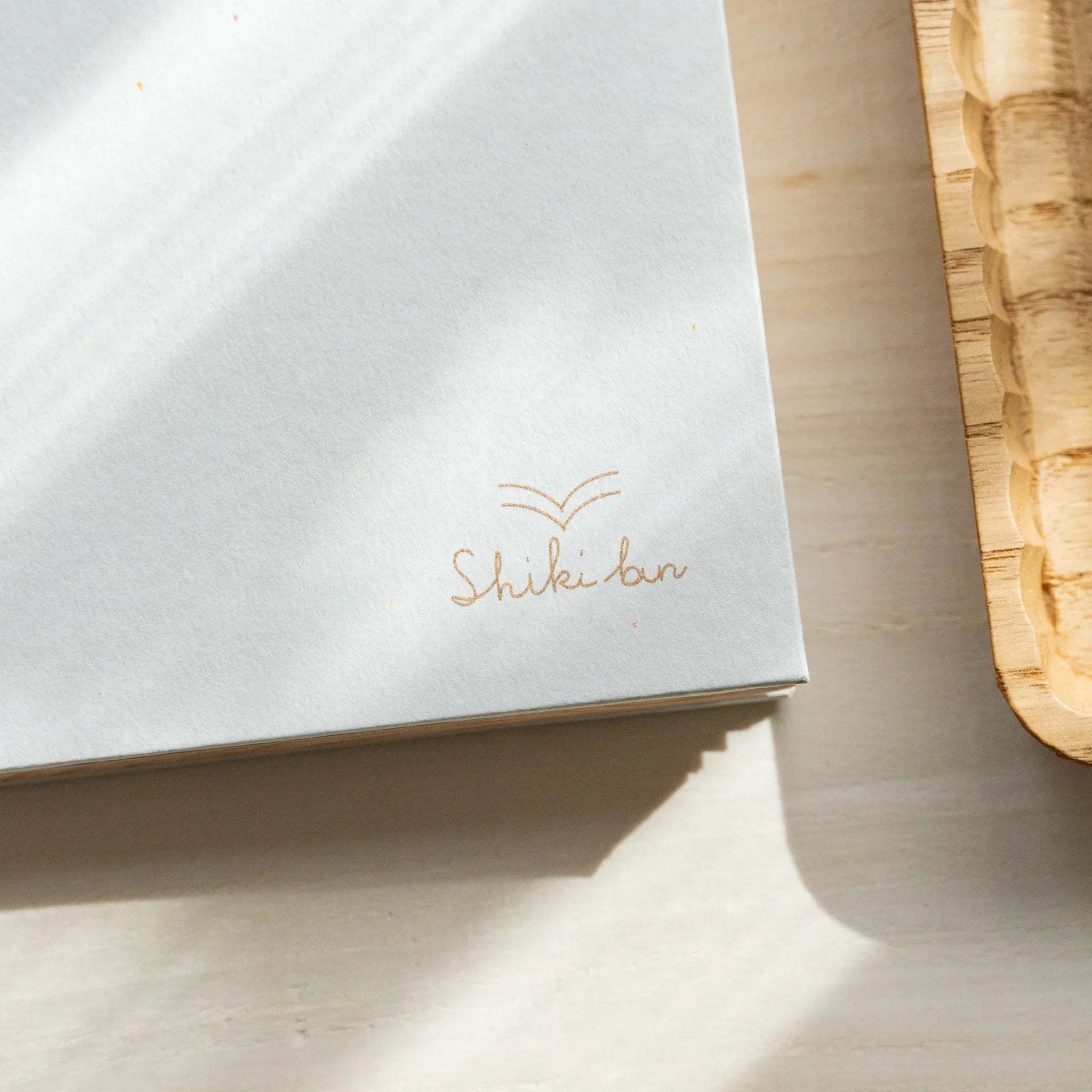 Red Pine B6 wooden page journal, multiple pages fanned showing natural wood grain variation showing natural wood material