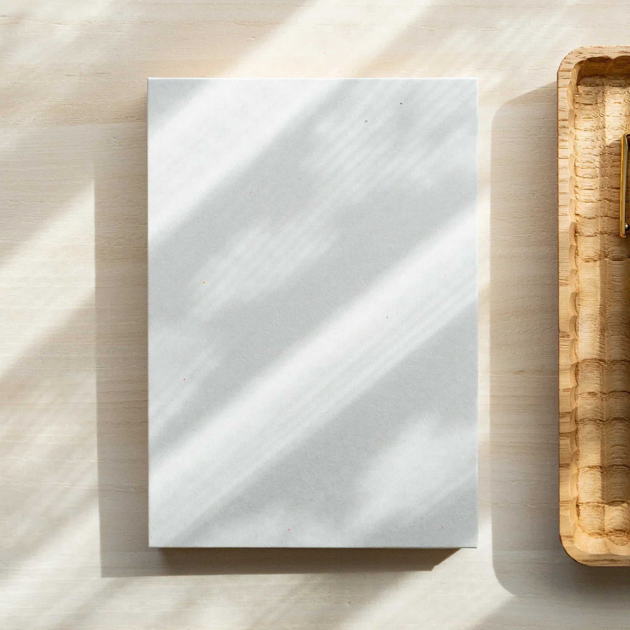 Red Pine B6 notebook with wooden pages, angled product marketing shot composition and design showing natural wood material