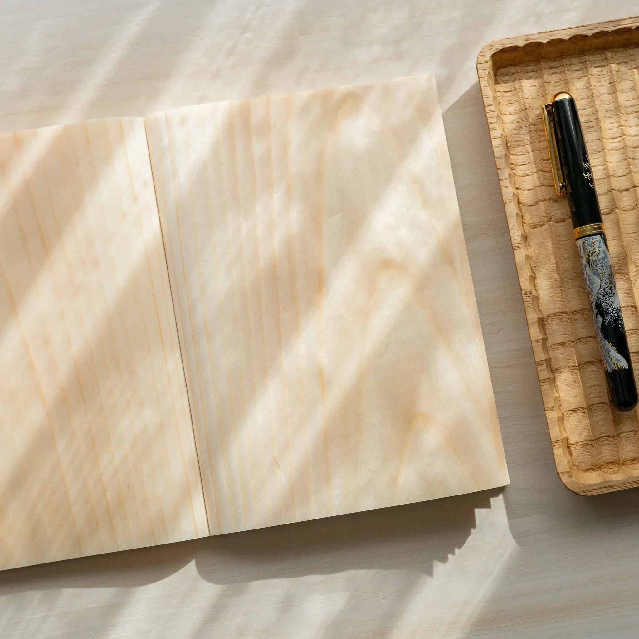 Wooden page red pine B6 notebook, corner detail showcasing natural wood craftsmanship and binding showing natural wood