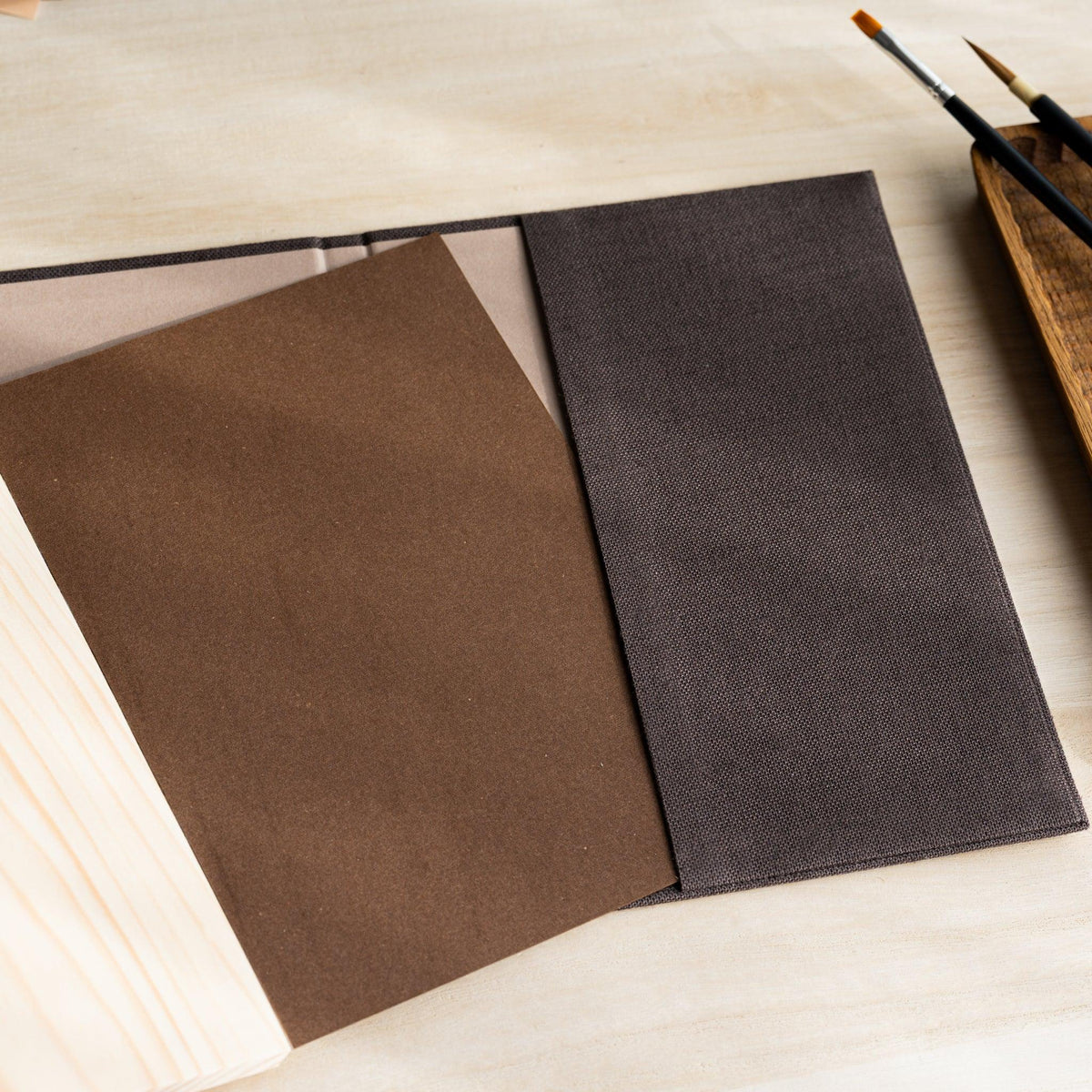 Red Pine Wooden Page Sketchbook Brown with the brown backing board of the page block lifted, wood page edge below