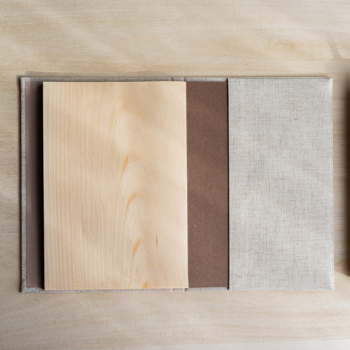 Red Pine Wooden Page Sketchbook Natural with wood pages folded back, brown backing board and linen cover visible