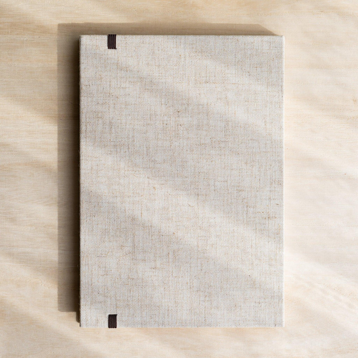 Red Pine Wooden Page Sketchbook Natural back cover, plain linen with dark brown elastic band ends at top and bottom