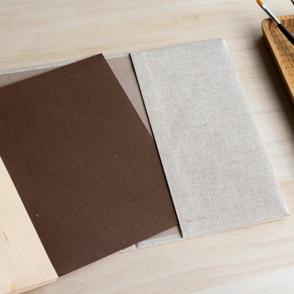 Red Pine Wooden Page Sketchbook Natural with the brown backing board of the page block lifted, wood page edge below