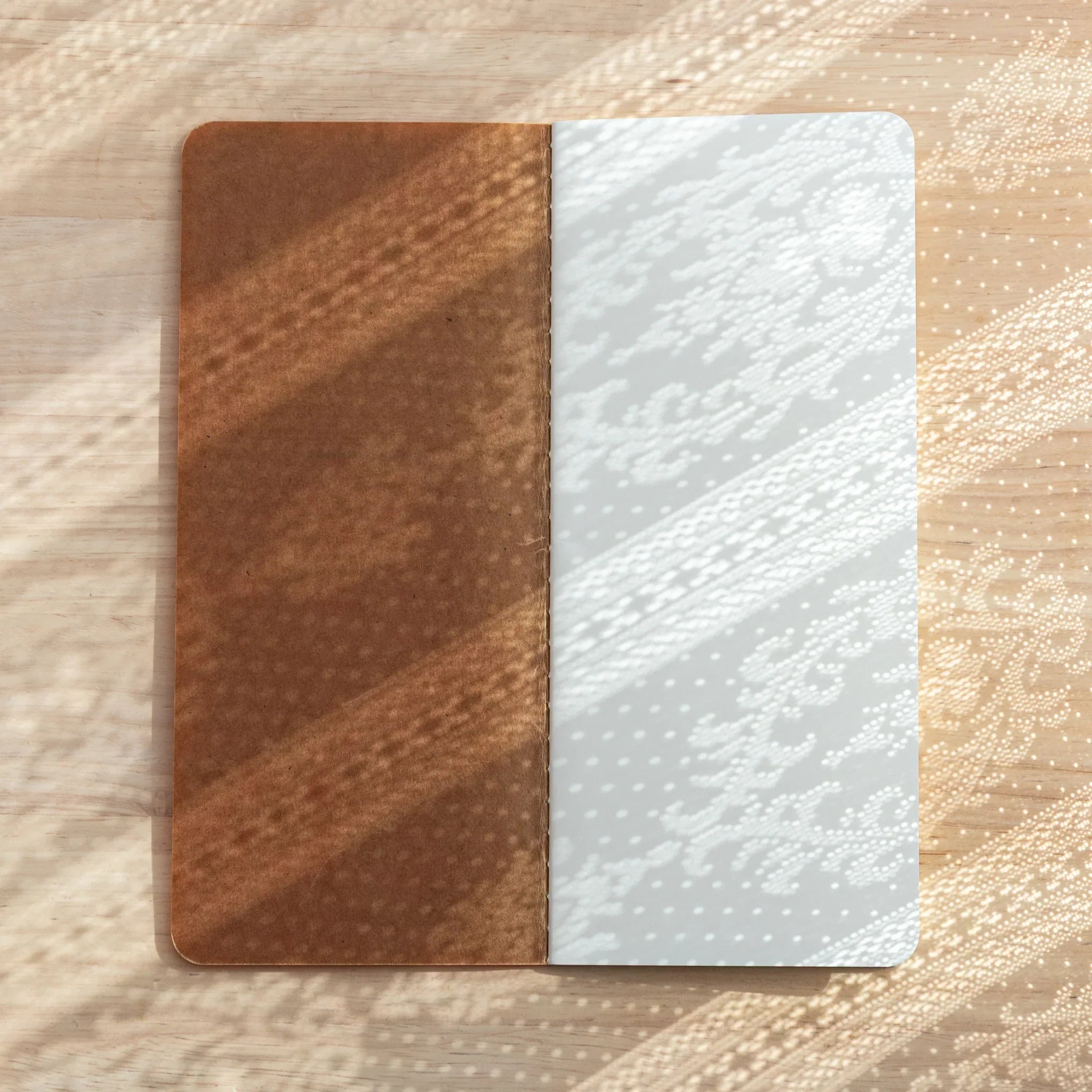 Japanese Notebook displayed on wooden desk, brown cover with 2mm squared design for Japanese Fountain Pen writing.