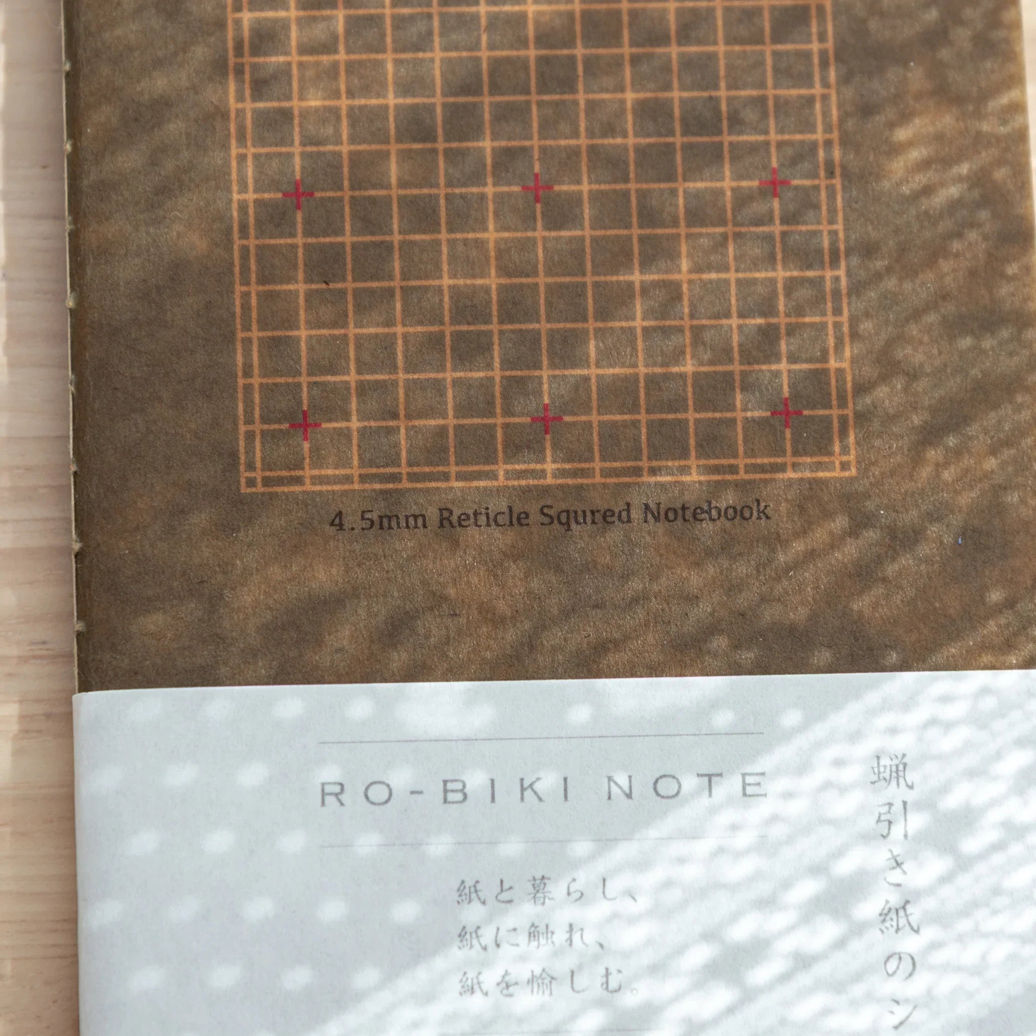 Close-up of beige Japanese Notebook with 4.5 mm grid, minimalist design, smooth for Japanese Fountain Pen.